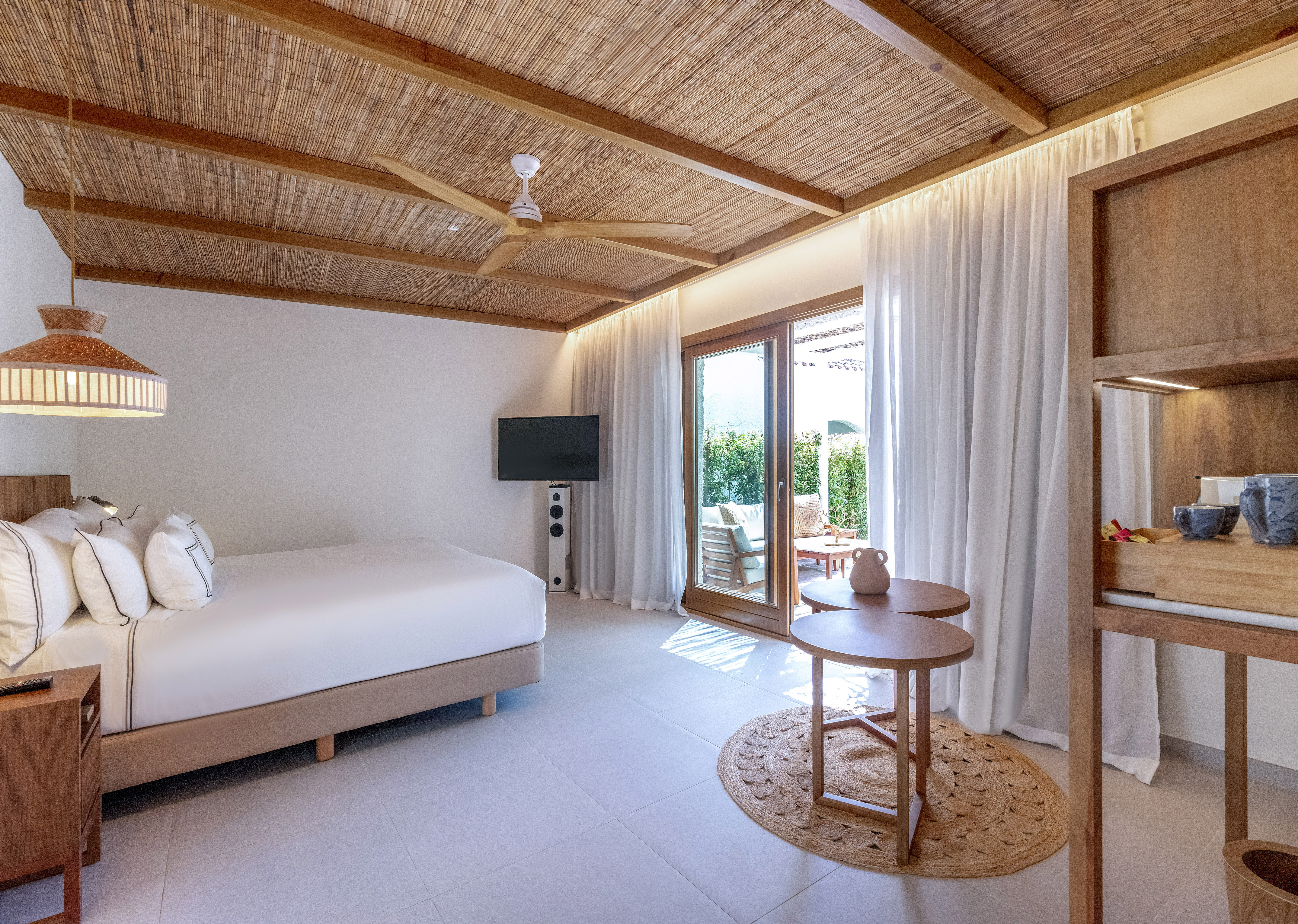 a room with a bed and a television