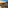 Golden Hour aerial of Marbella coast, luxury homes, mountains, and sea.
