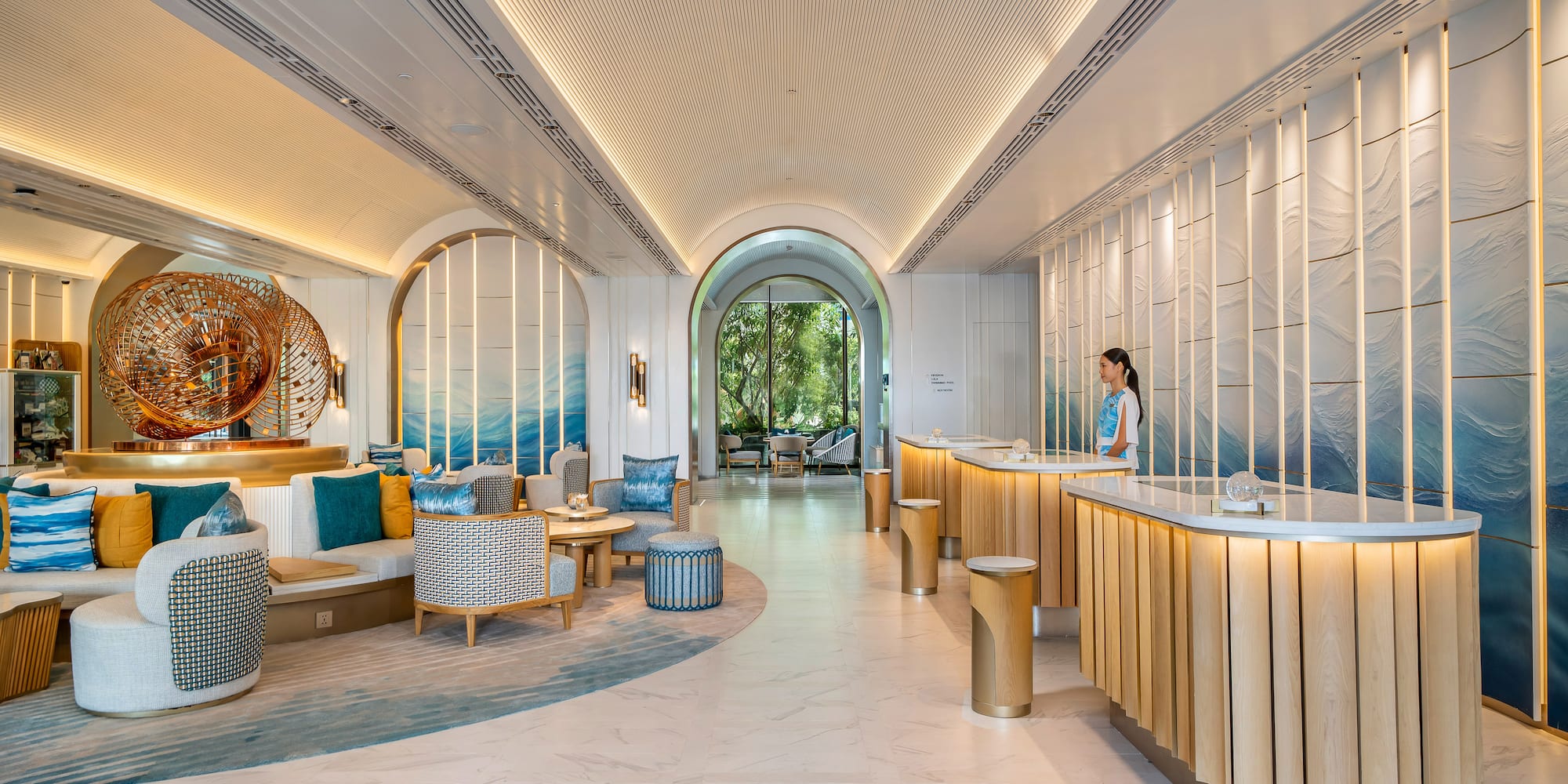 a lobby with a woman standing behind a counter