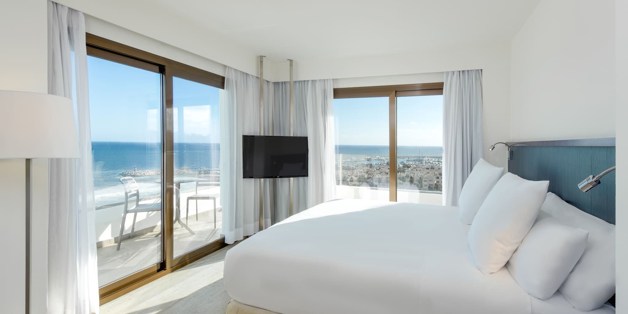 a bedroom with a large bed and a television