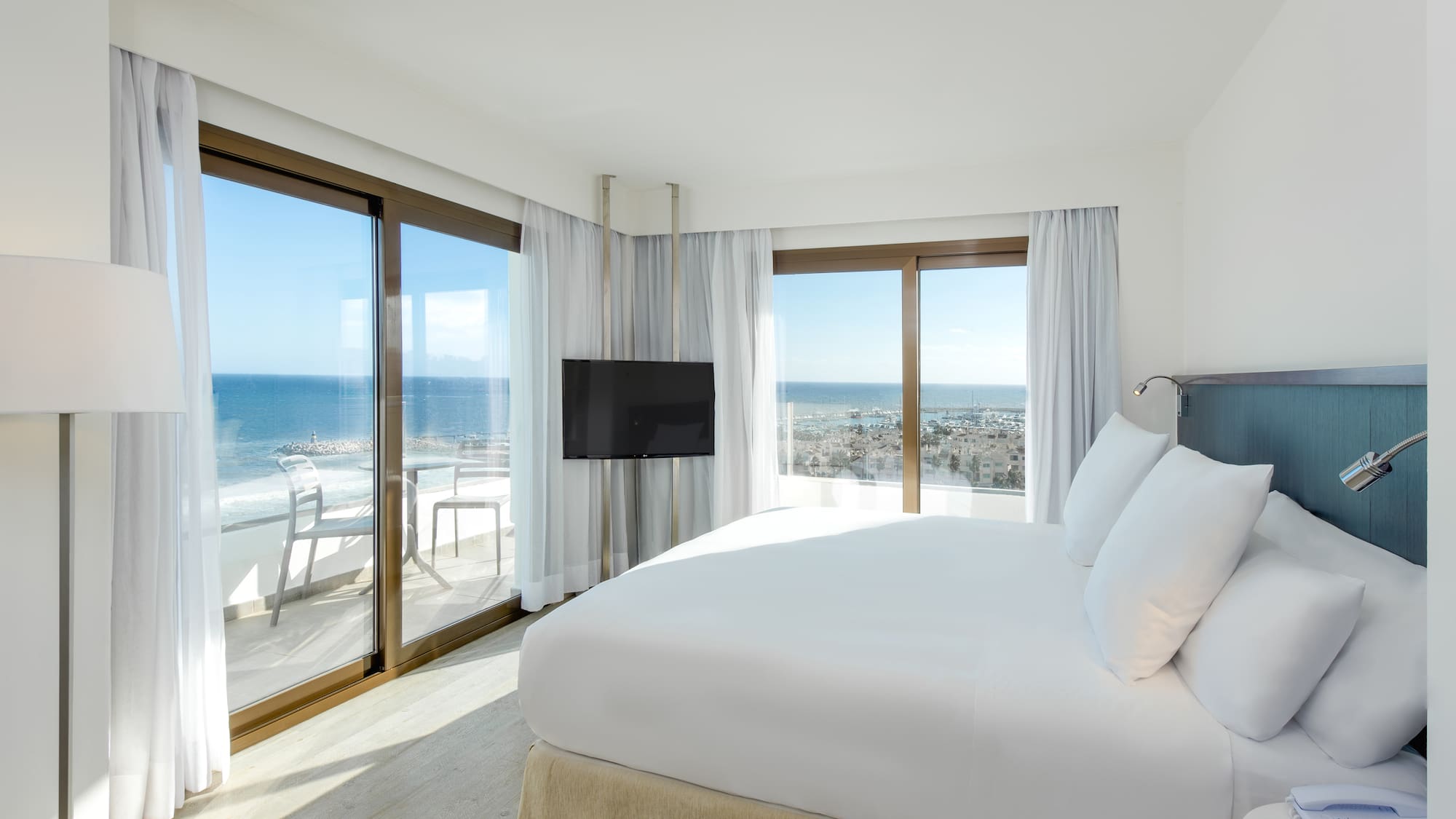 a bedroom with a large bed and a television