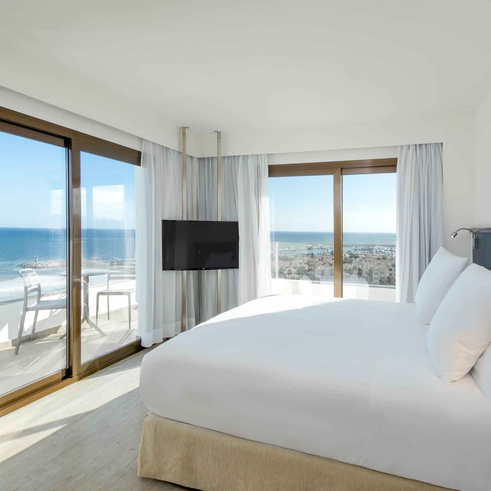 a bedroom with a large bed and a television