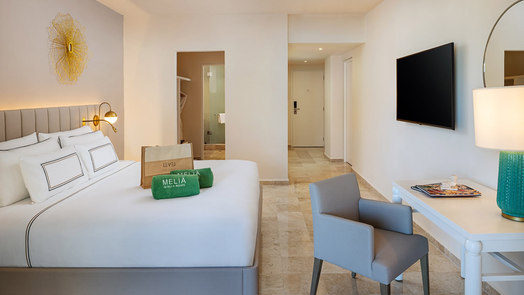 a room with a bed and a television