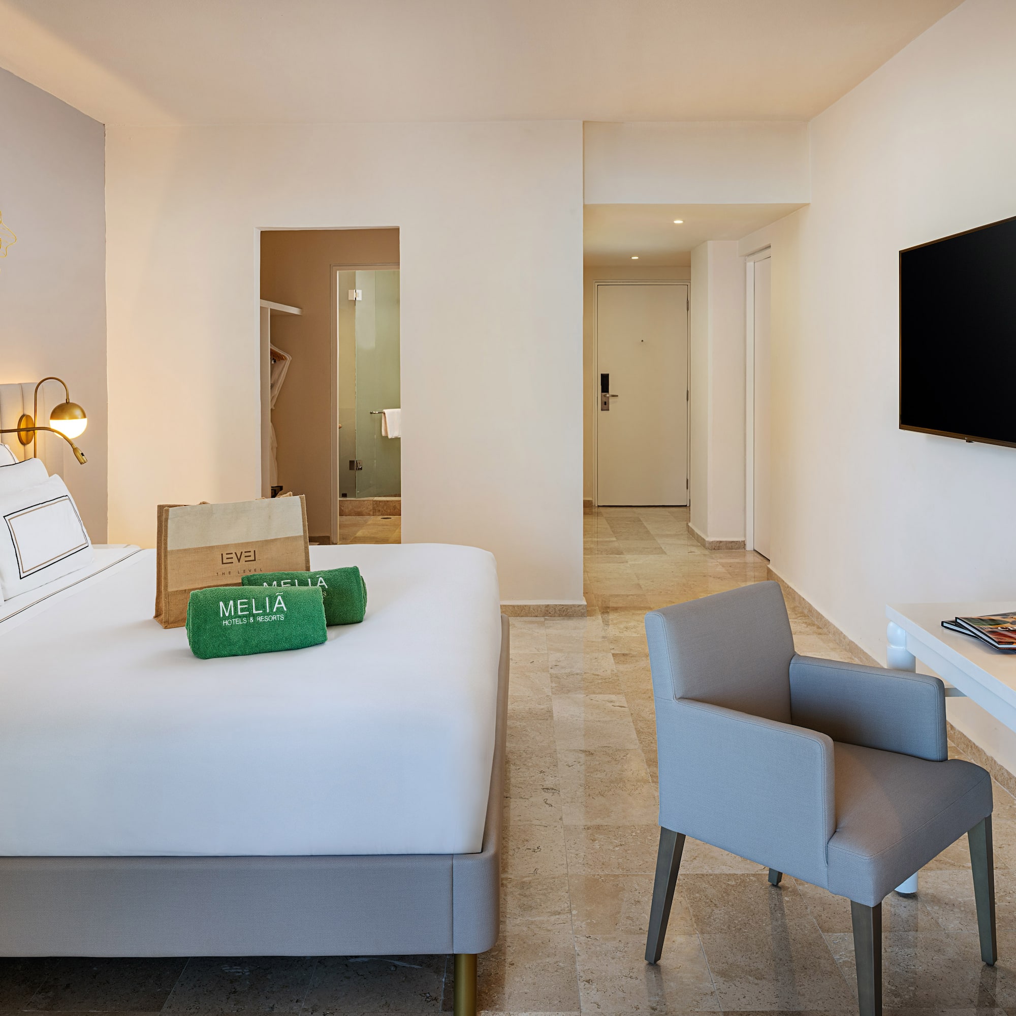 a room with a bed and a television