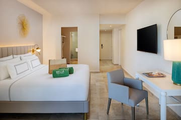 a room with a bed and a television