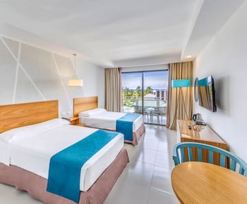 a room with two beds and a table