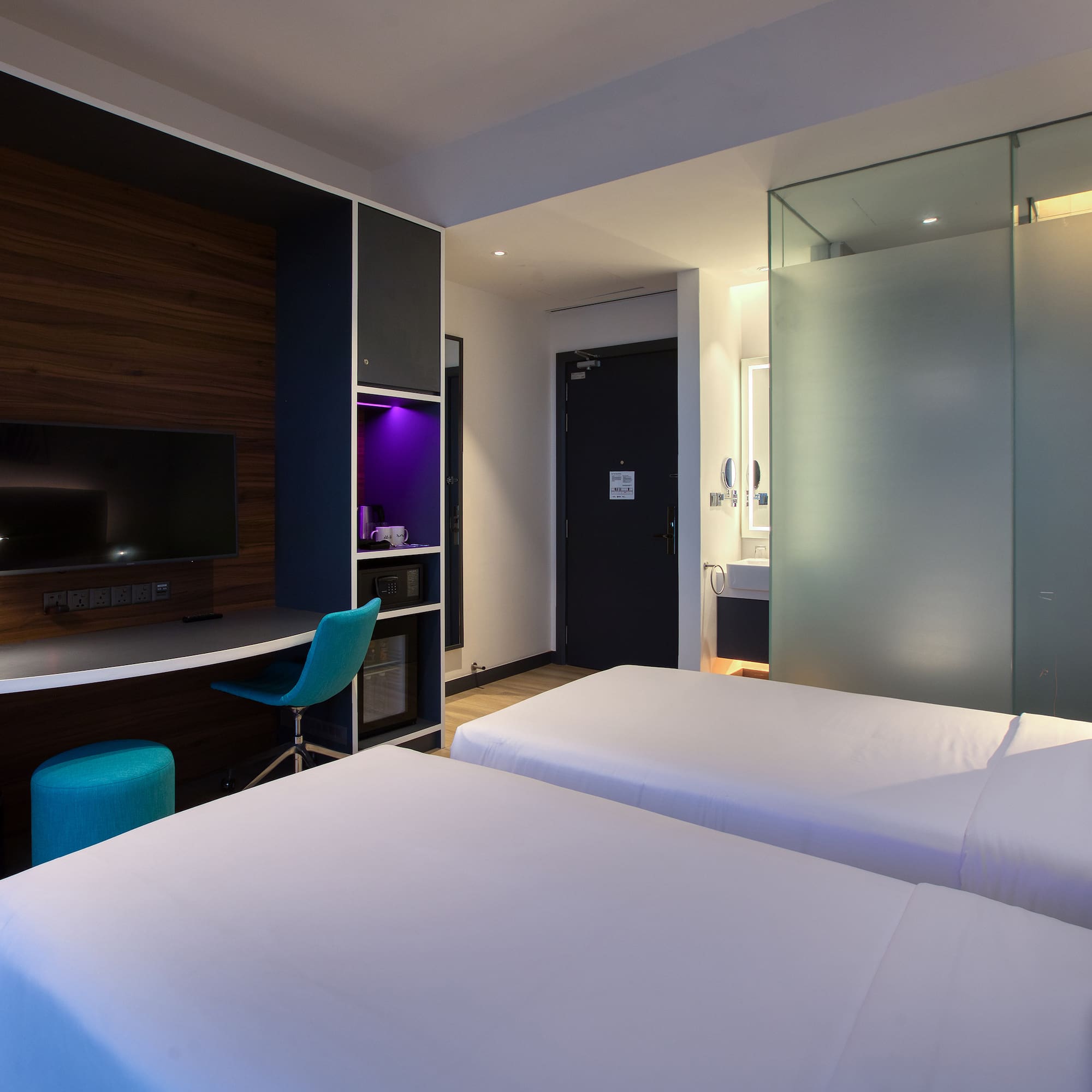 a room with two beds and a desk