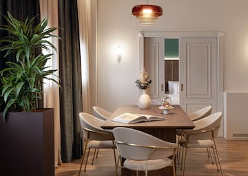 a dining table with chairs and a plant