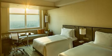 a room with two beds and a desk