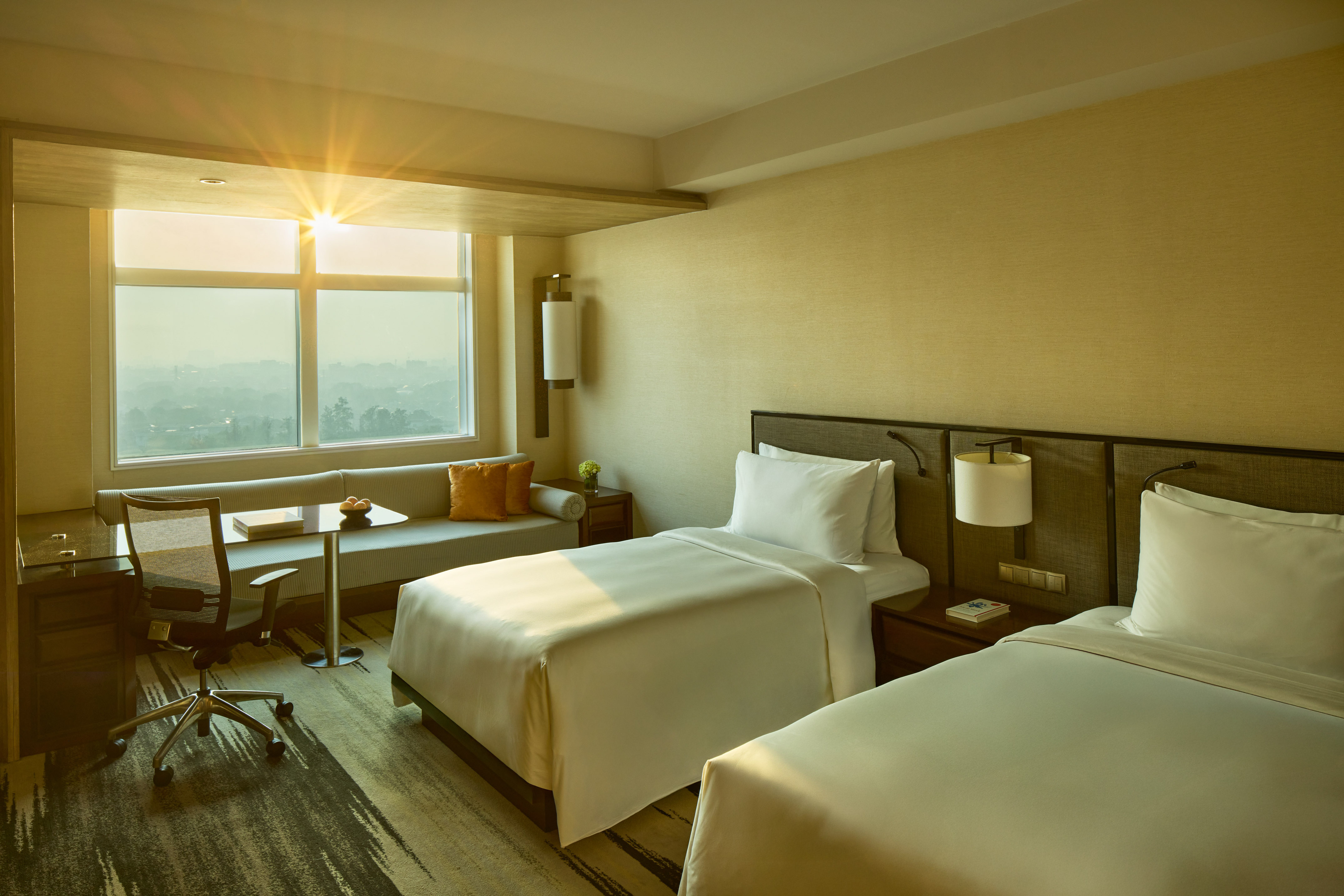 a room with two beds and a desk