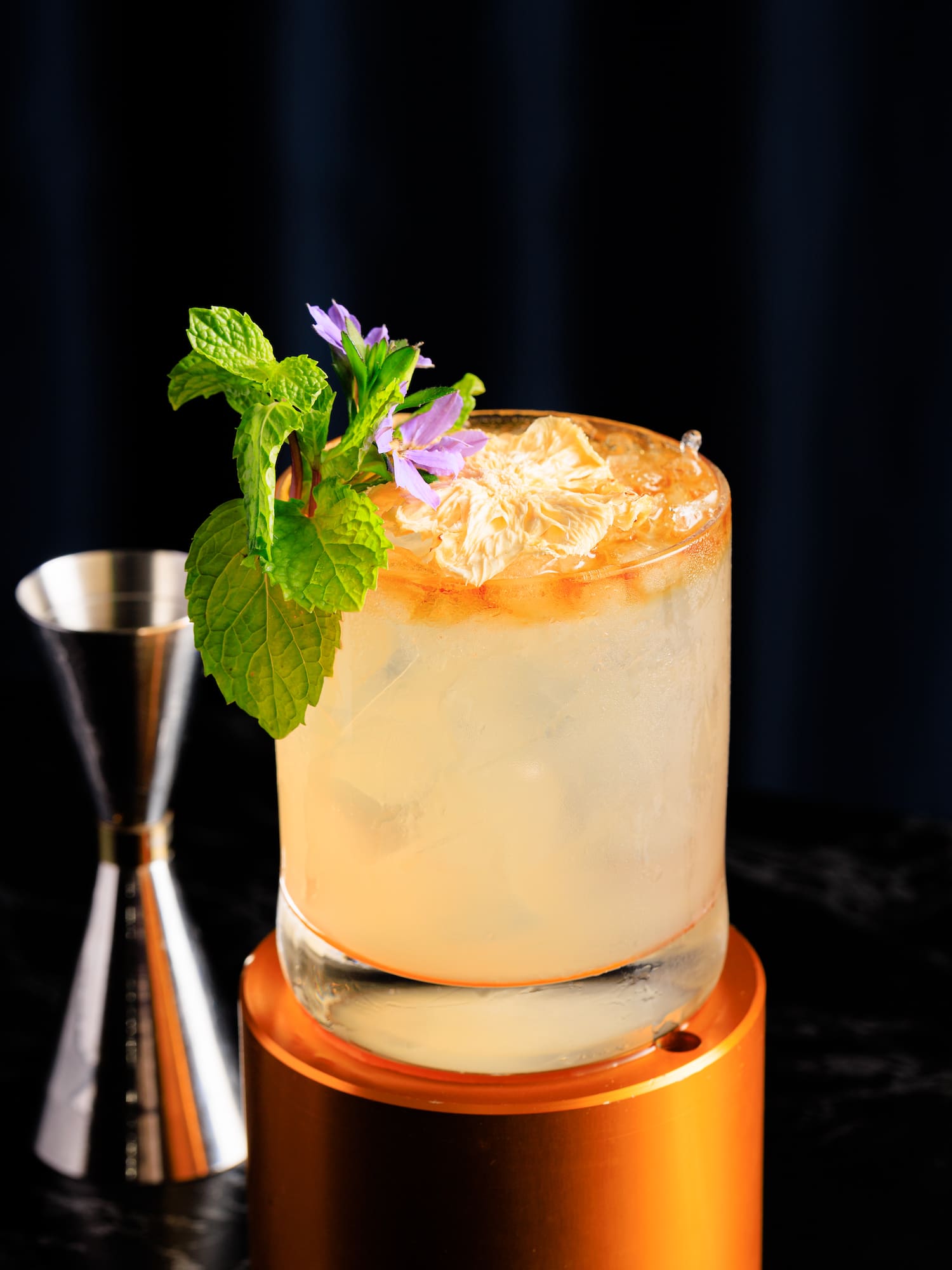a glass with ice and a flower on top