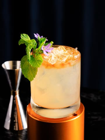a glass with ice and a flower on top