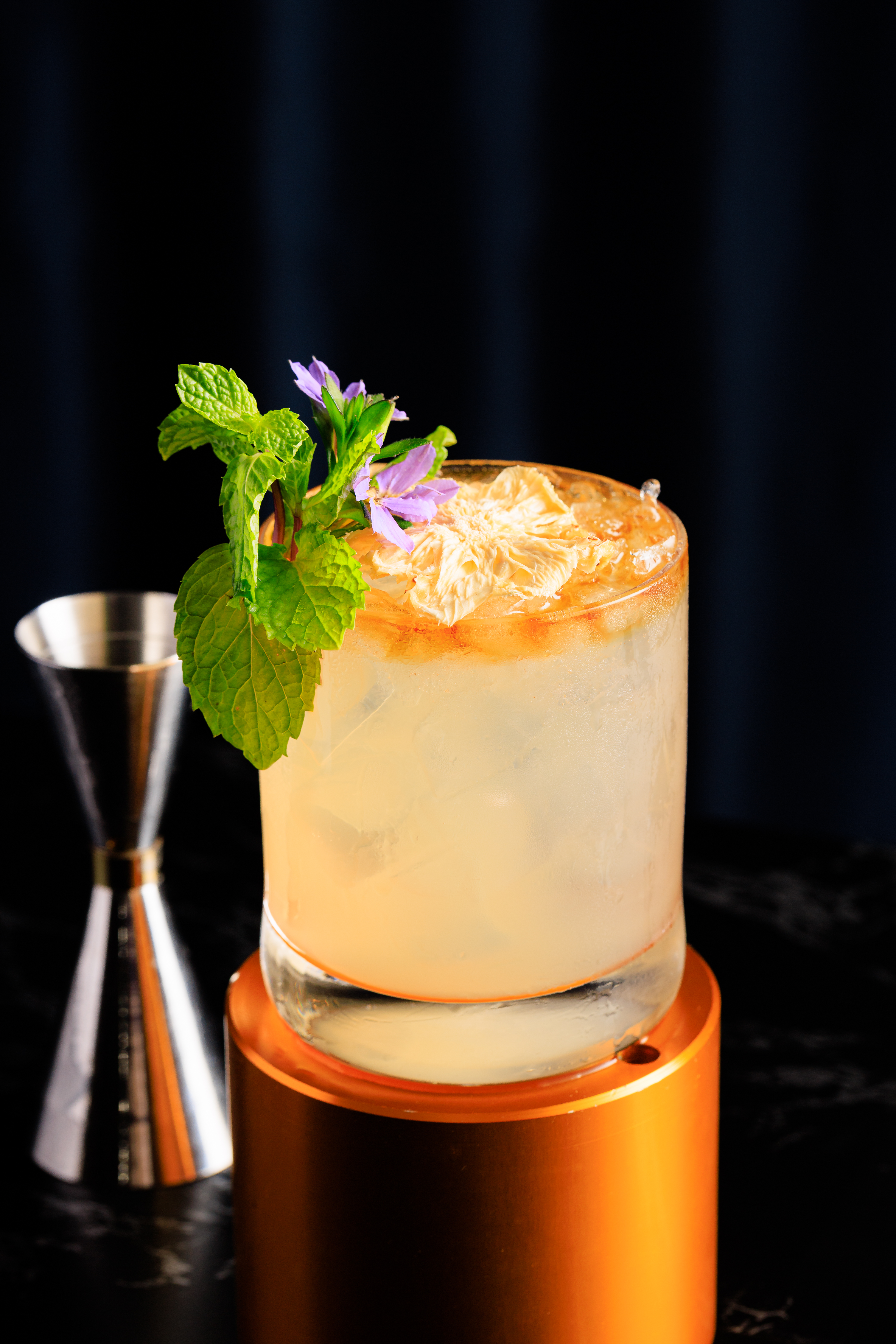 a glass with ice and a flower on top