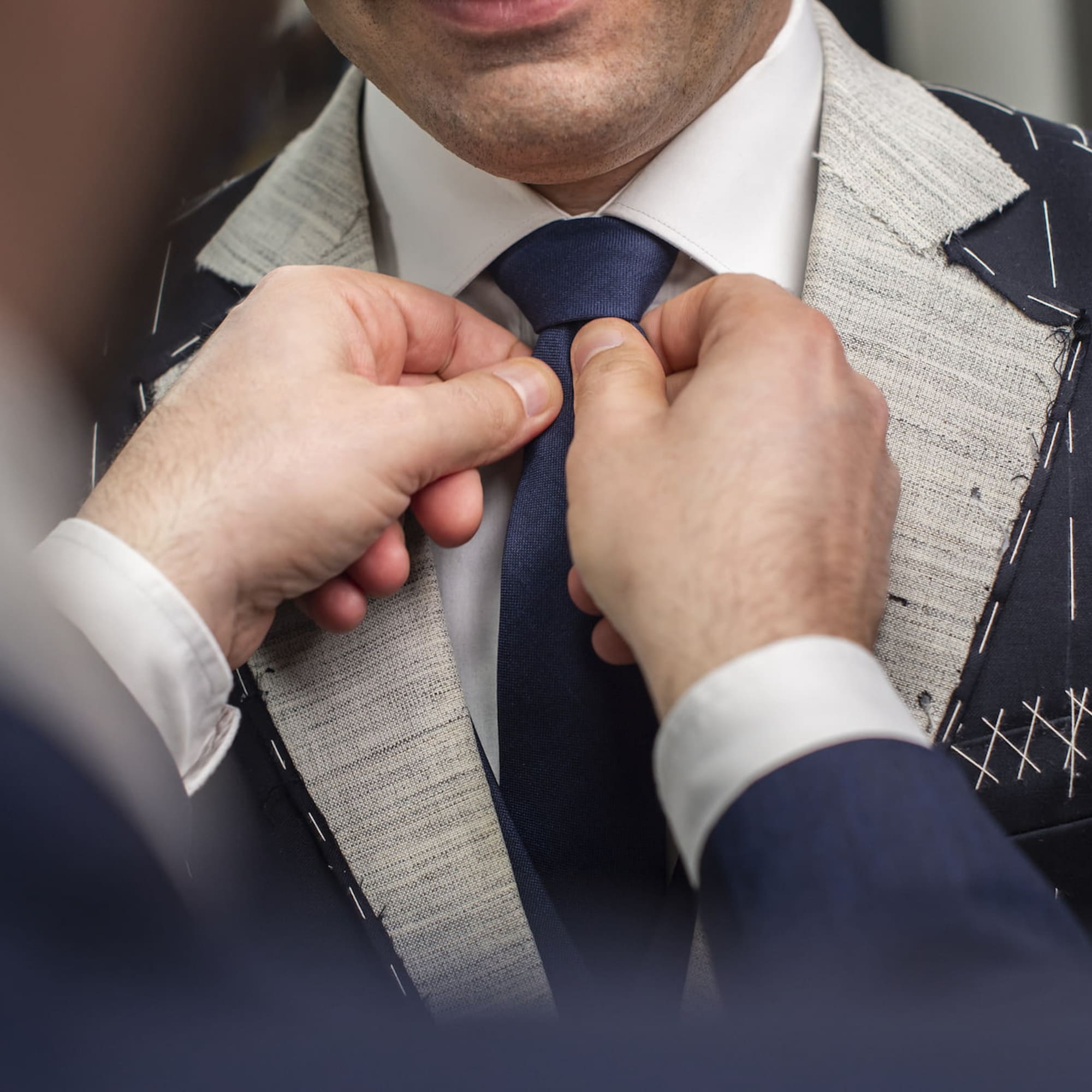a man tying a tie