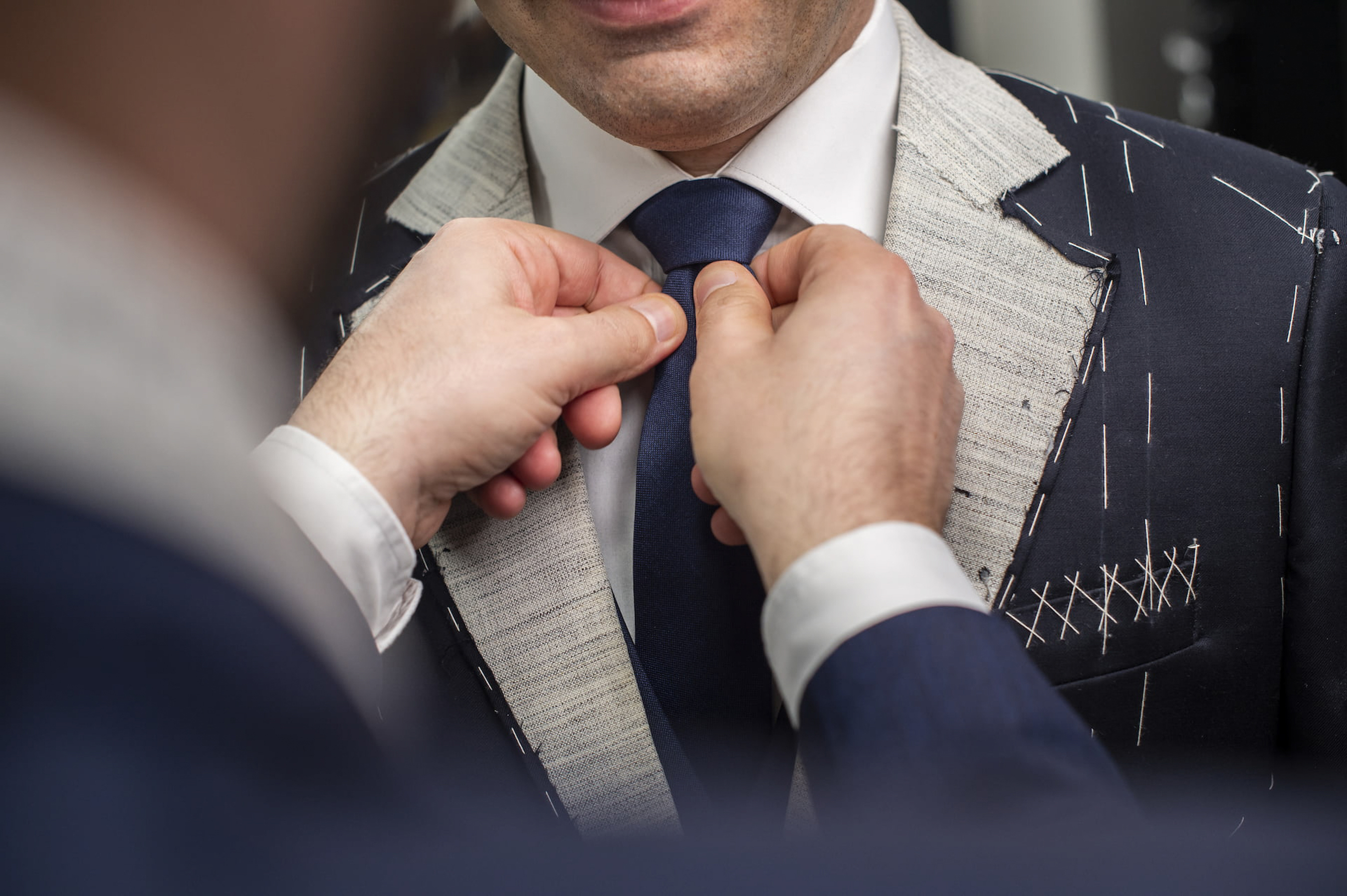 a man tying a tie