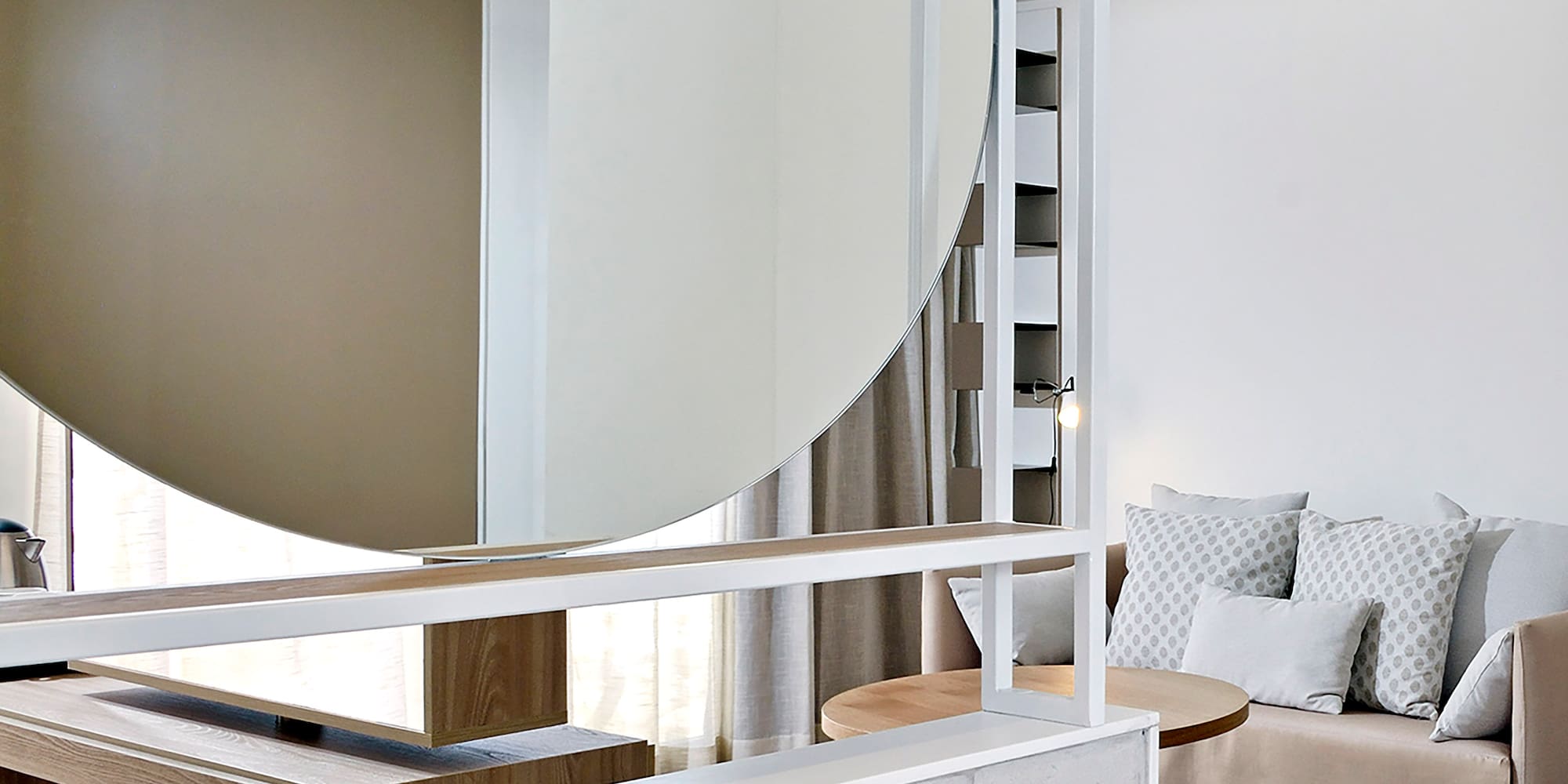 a bathroom with a large round mirror