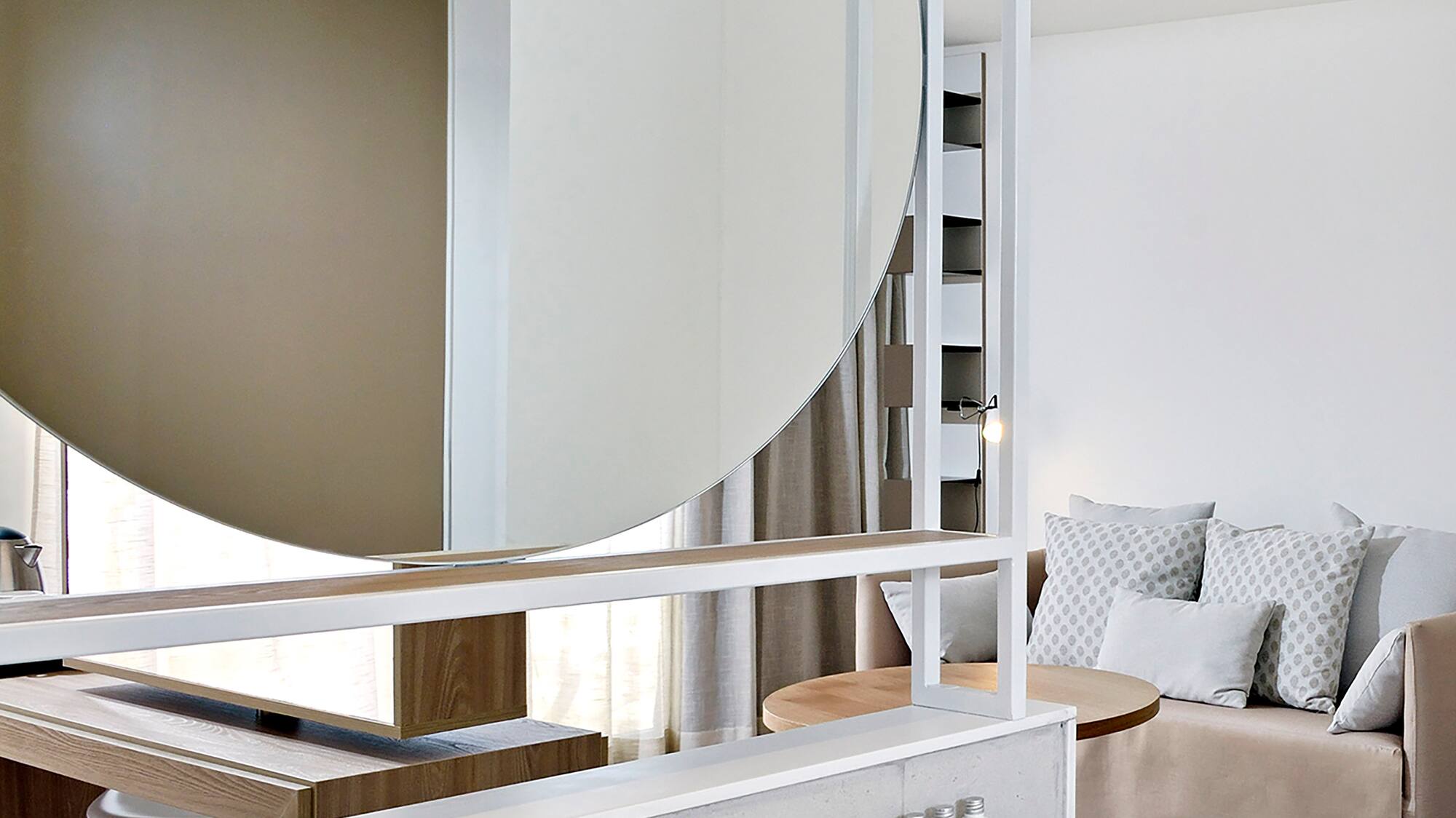 a bathroom with a large round mirror