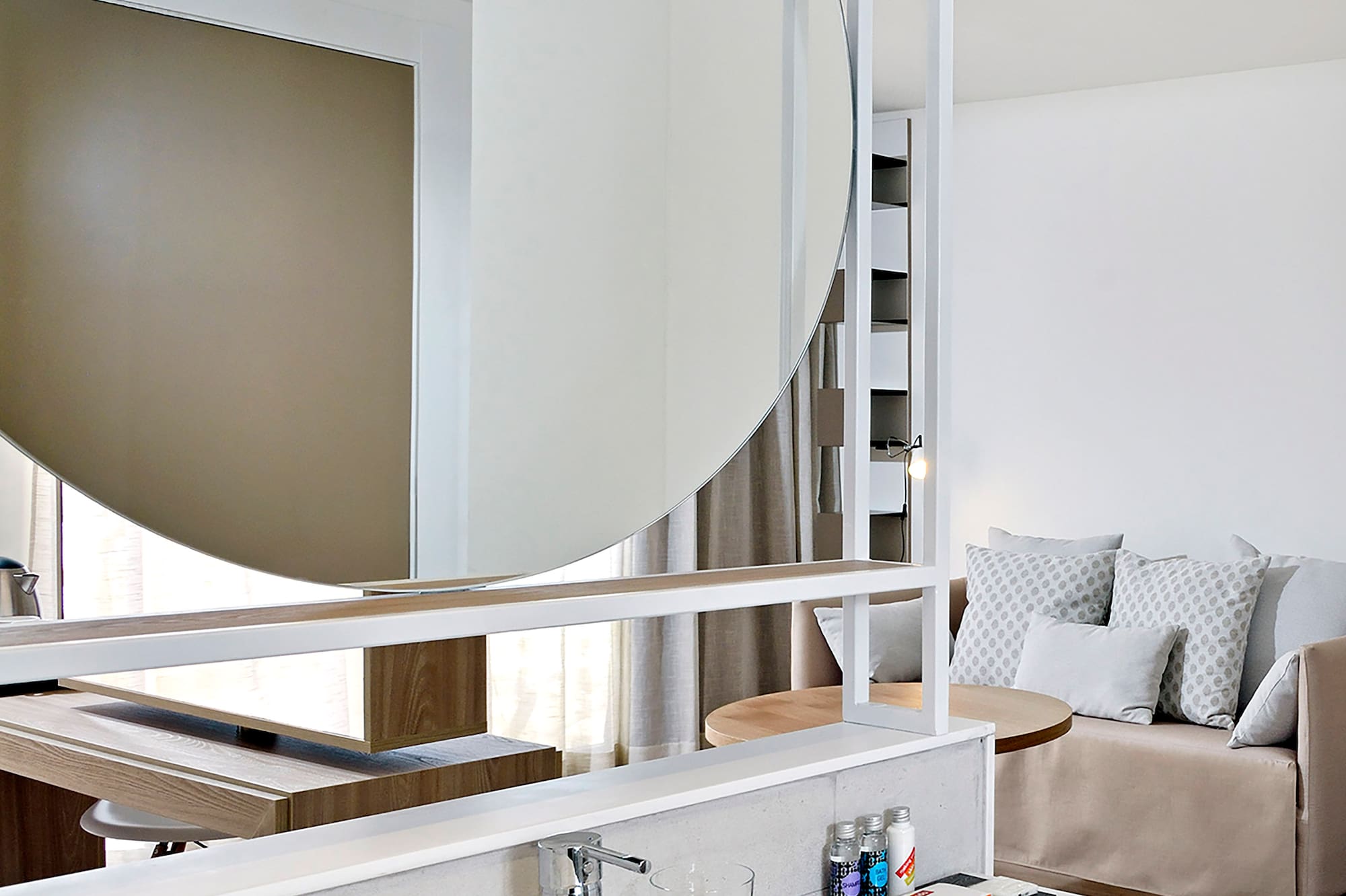 a bathroom with a large round mirror