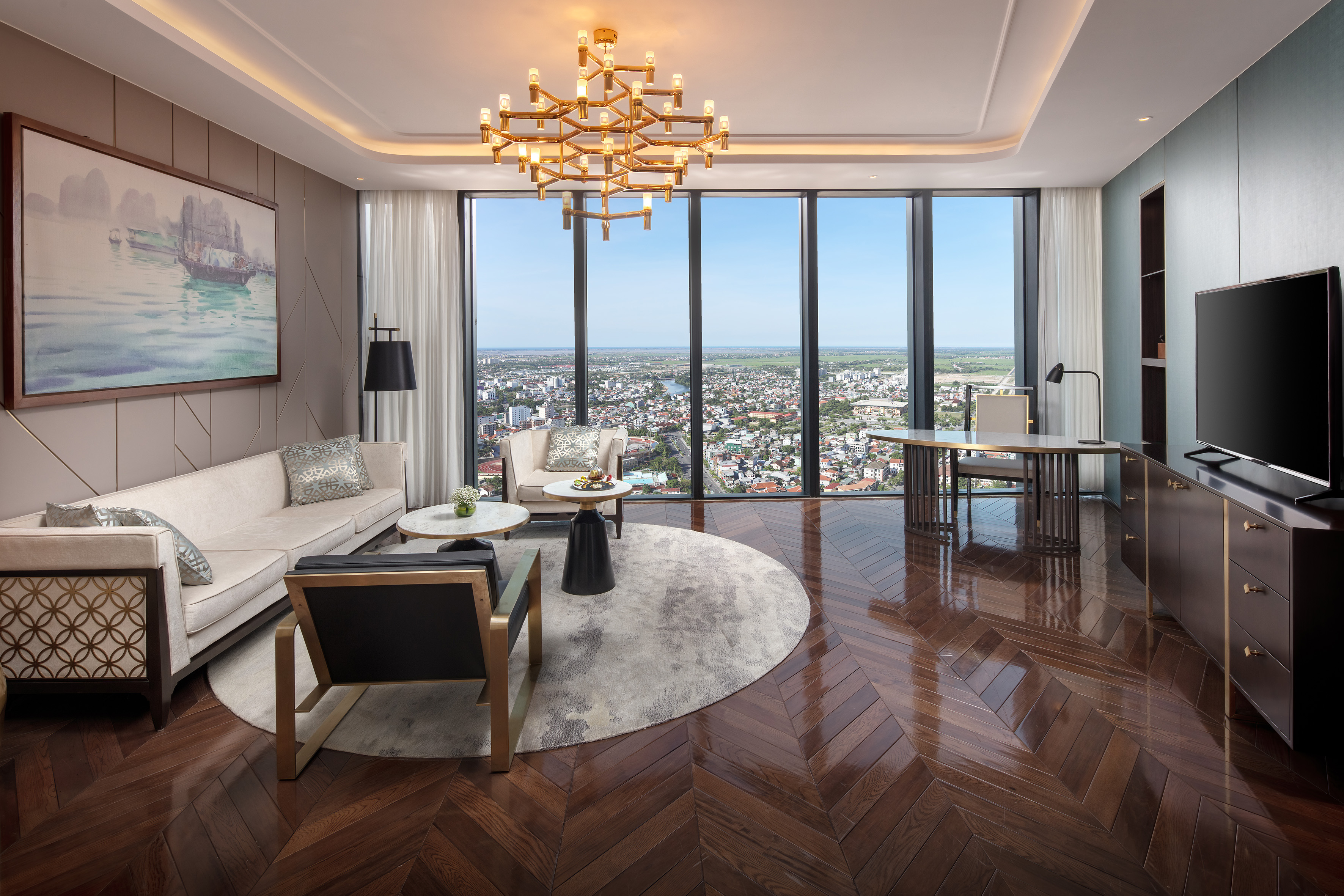 Luxury living room with city view, modern furniture, herringbone floor, and elegant decor.