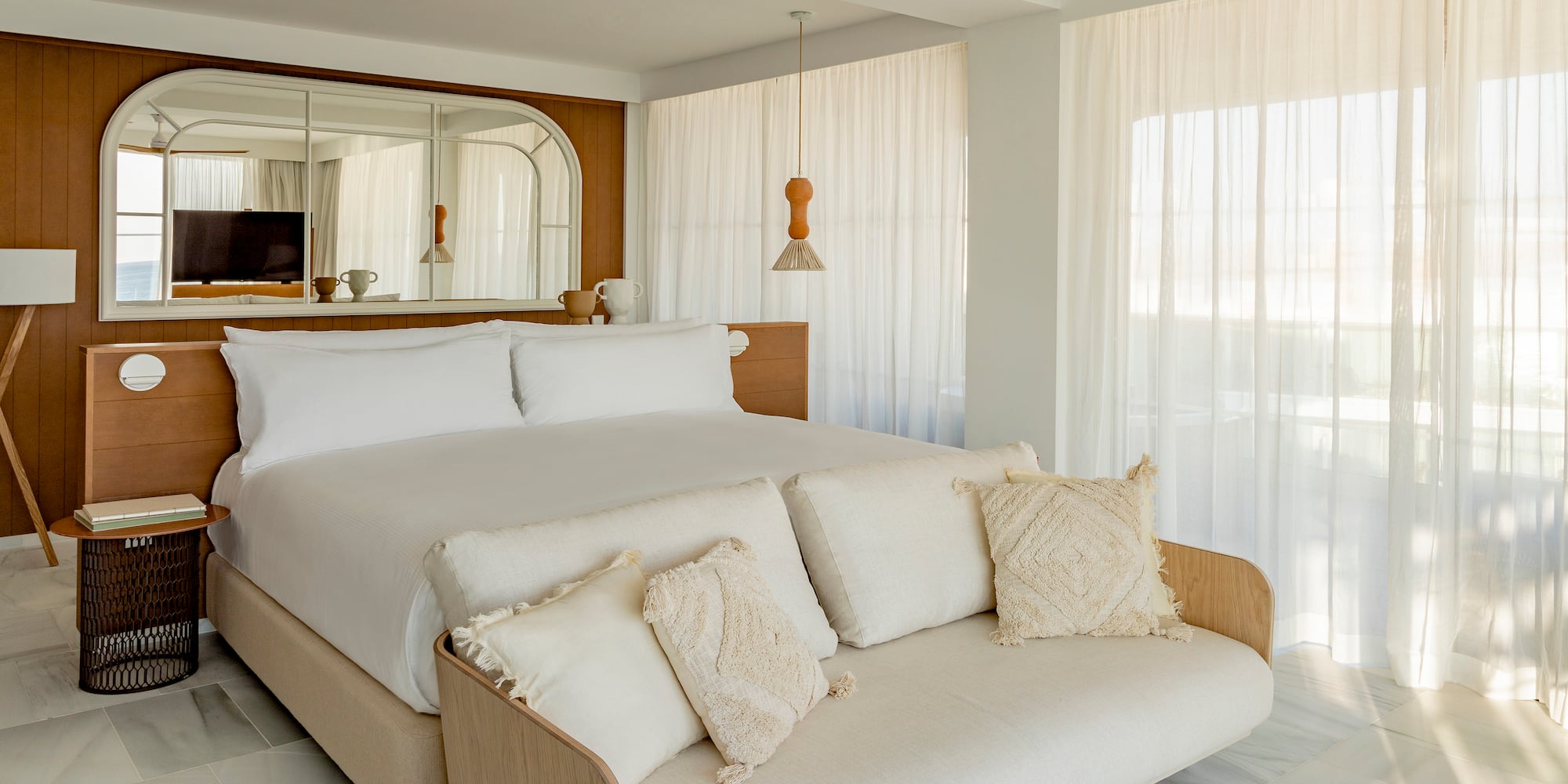 a bed in a room with a ceiling fan