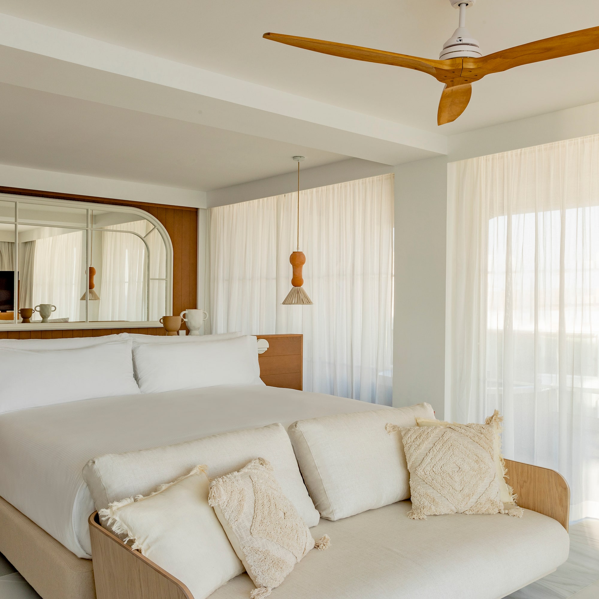a bed in a room with a ceiling fan