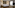 Modern hotel bedroom with large bed, warm backlighting, wood floor, TV, window.