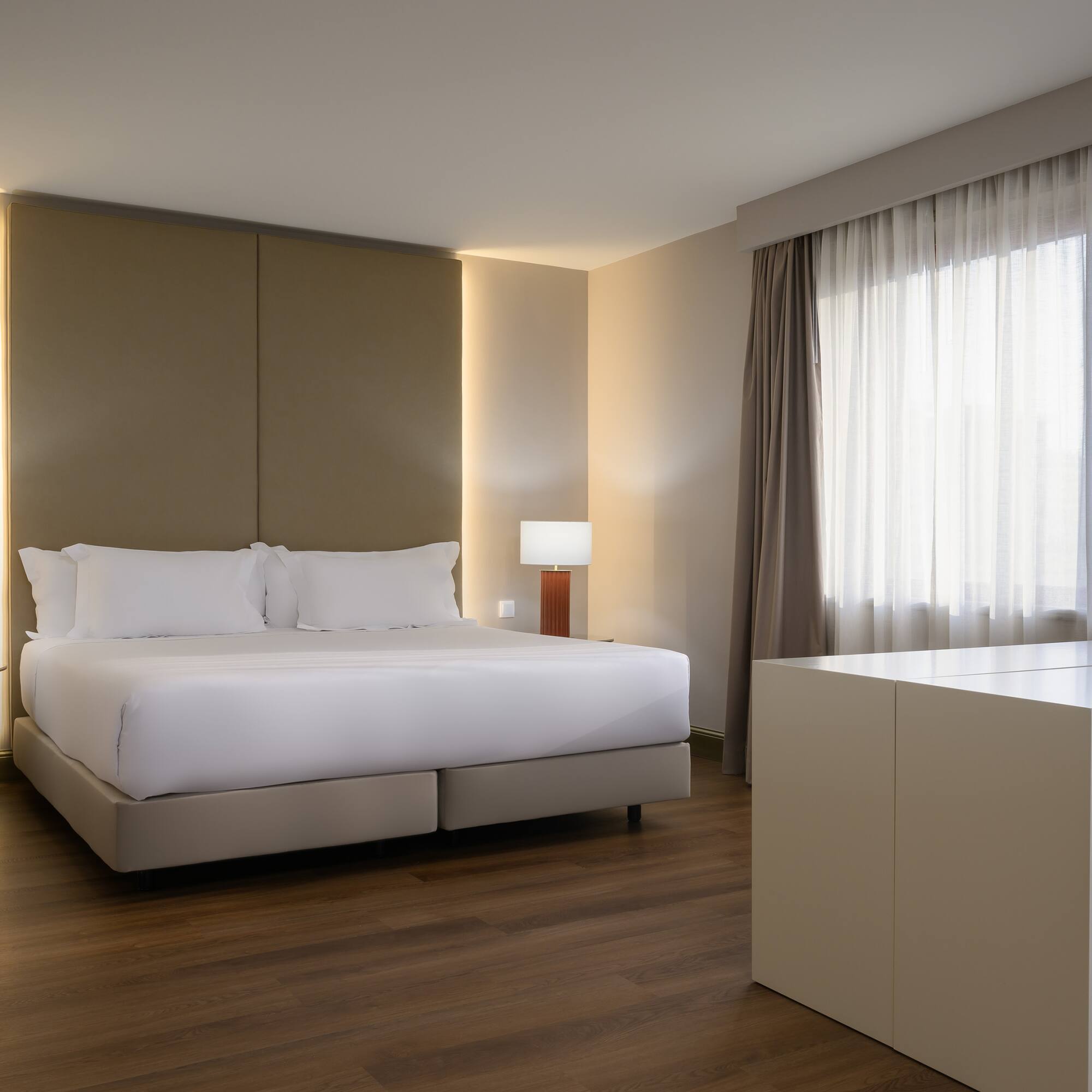 a bedroom with a bed and a table