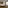 Modern hotel bedroom with large bed, warm backlighting, wood floor, TV, window.