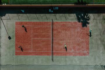 a tennis court with people playing tennis