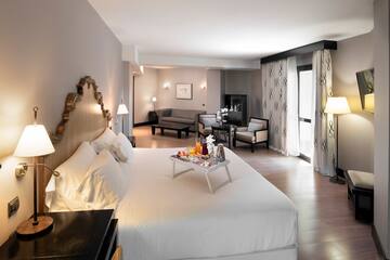 a hotel room with a bed and a television