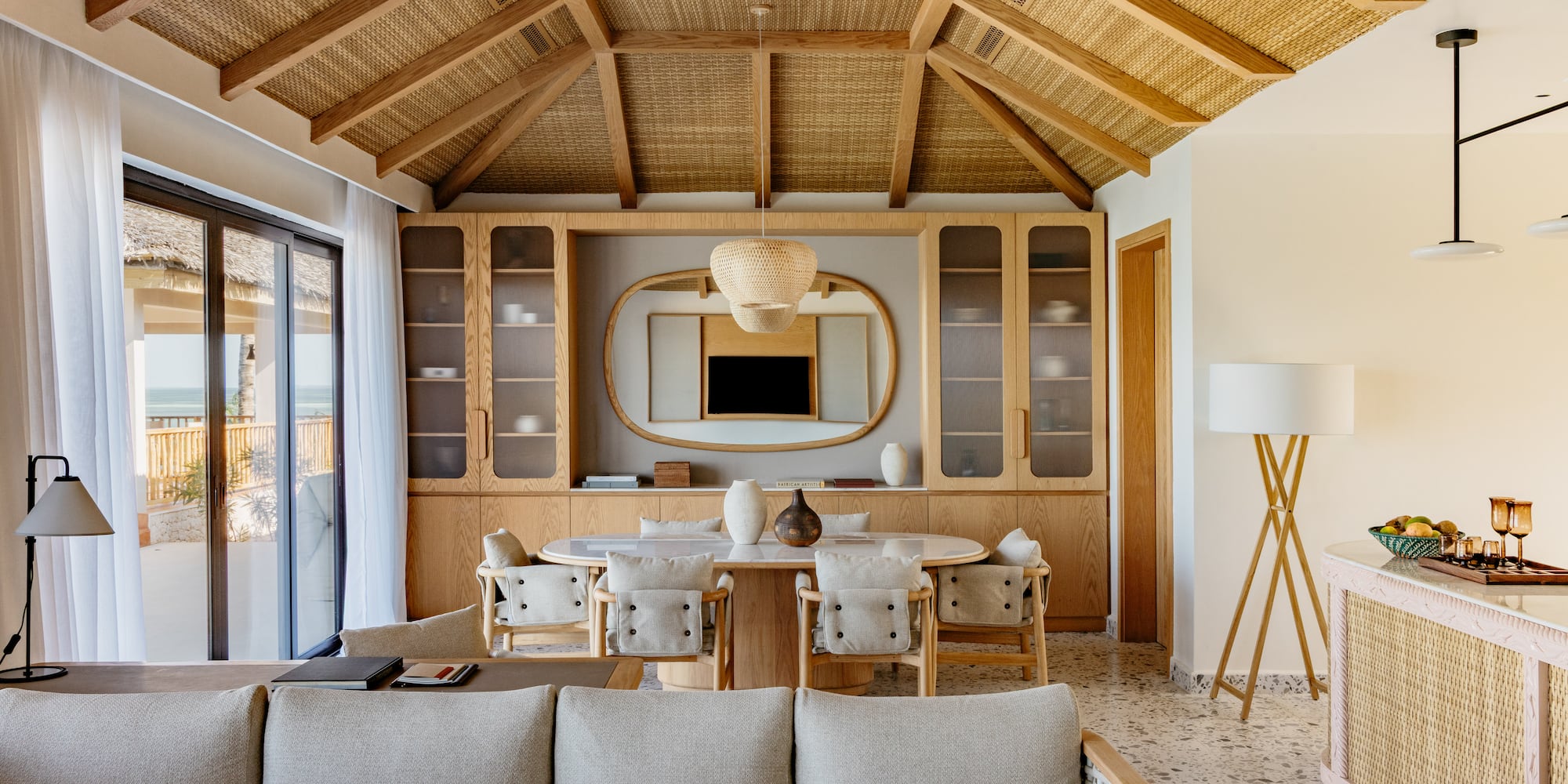 a living room with a table and chairs