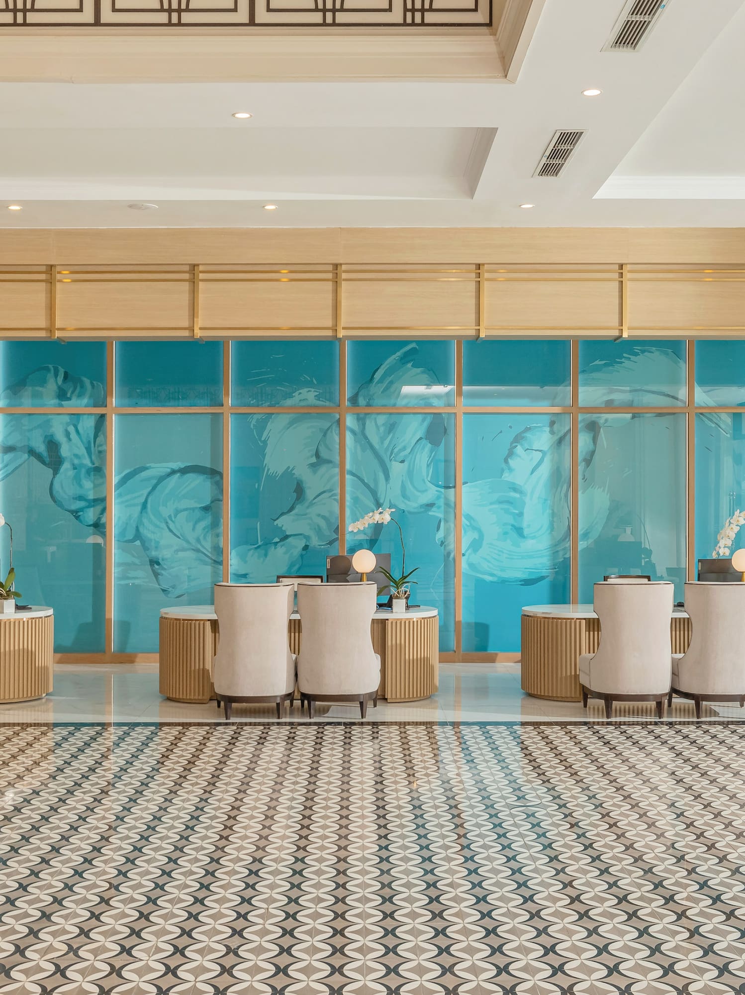 a room with a large glass wall and a large table with chairs