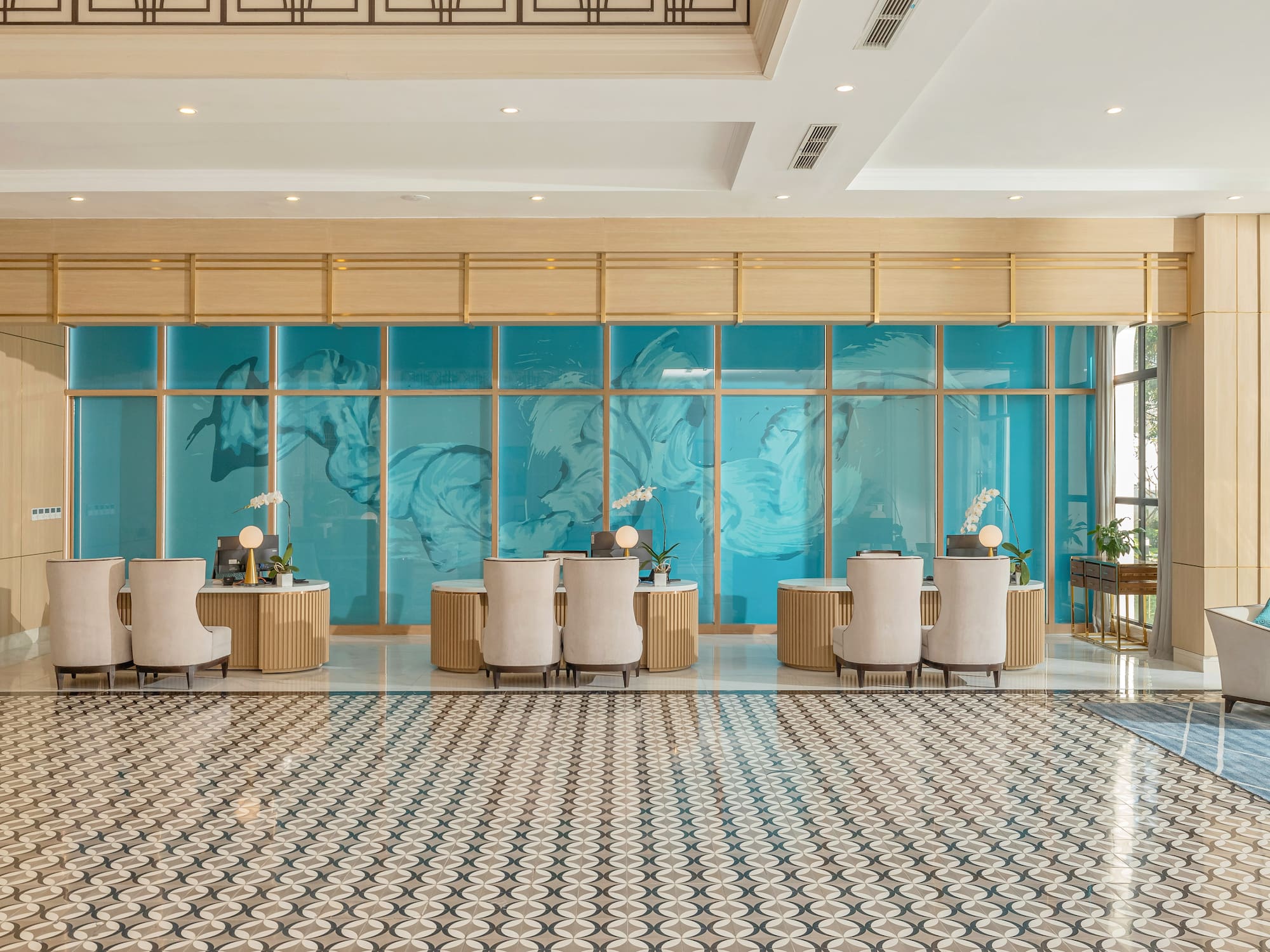 a room with a large glass wall and a large table with chairs