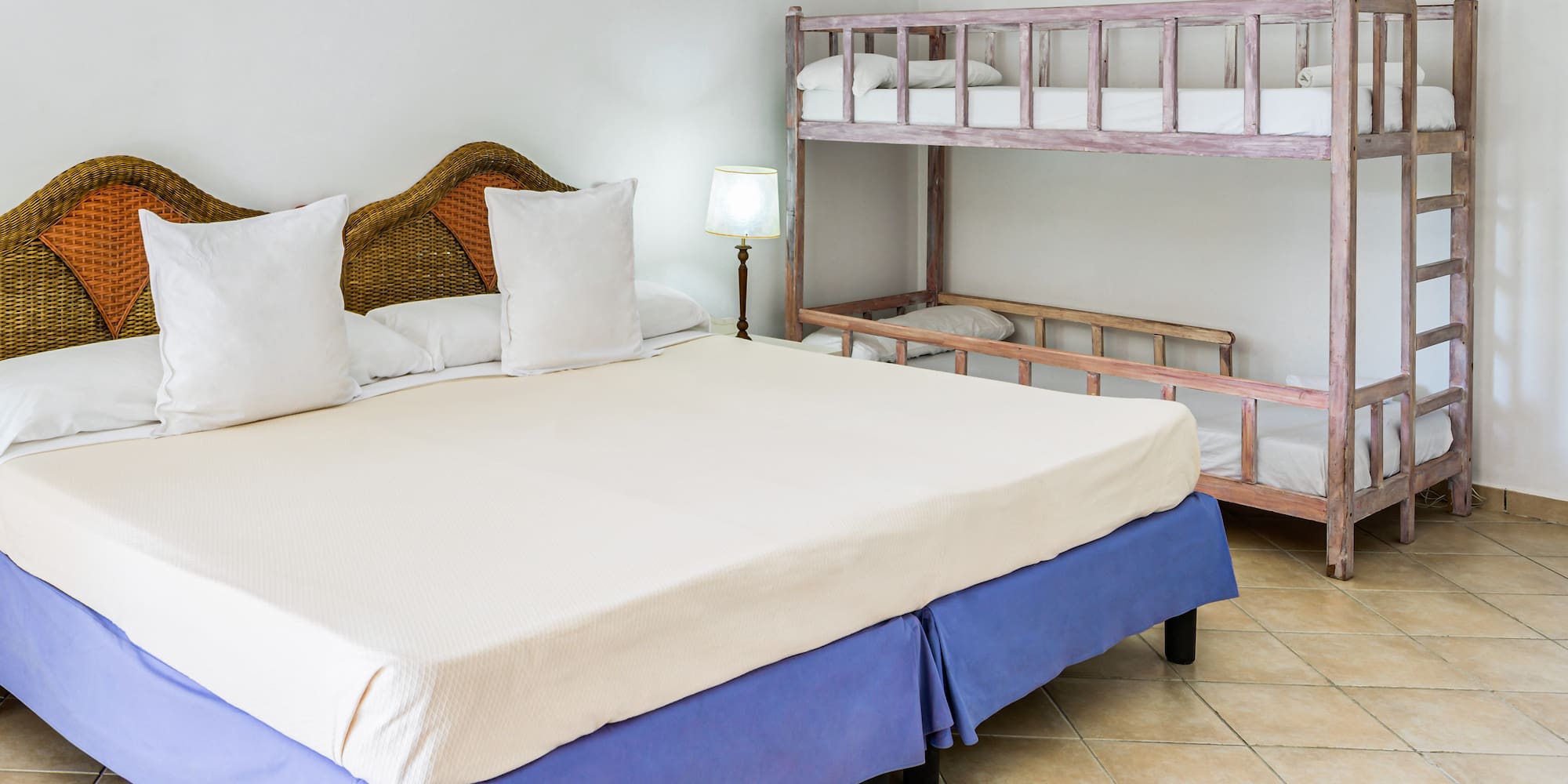 a bed with white pillows and a bunk bed