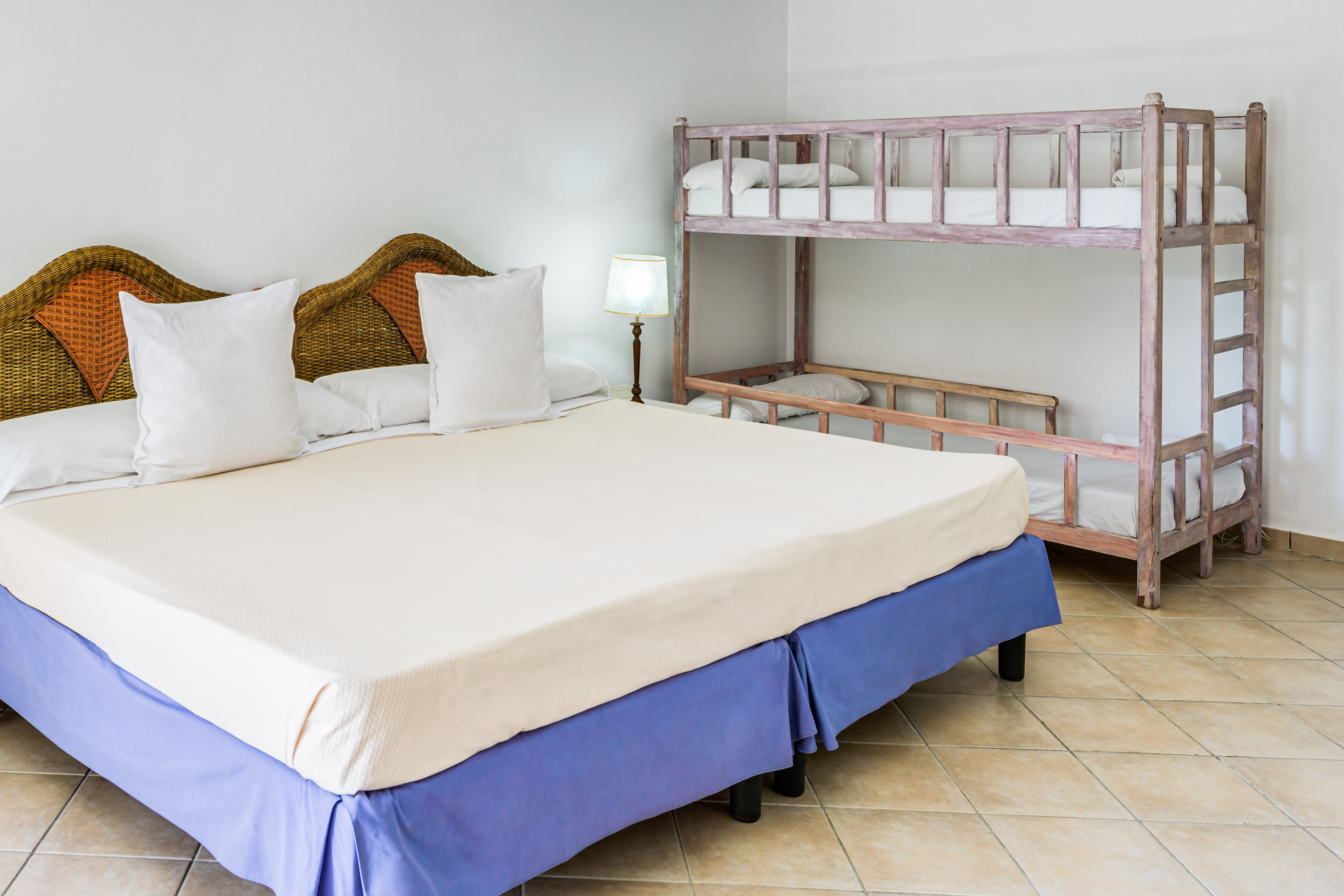 a bed with white pillows and a bunk bed