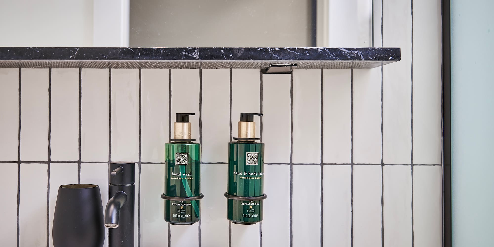 a bathroom with a sink and soap dispenser