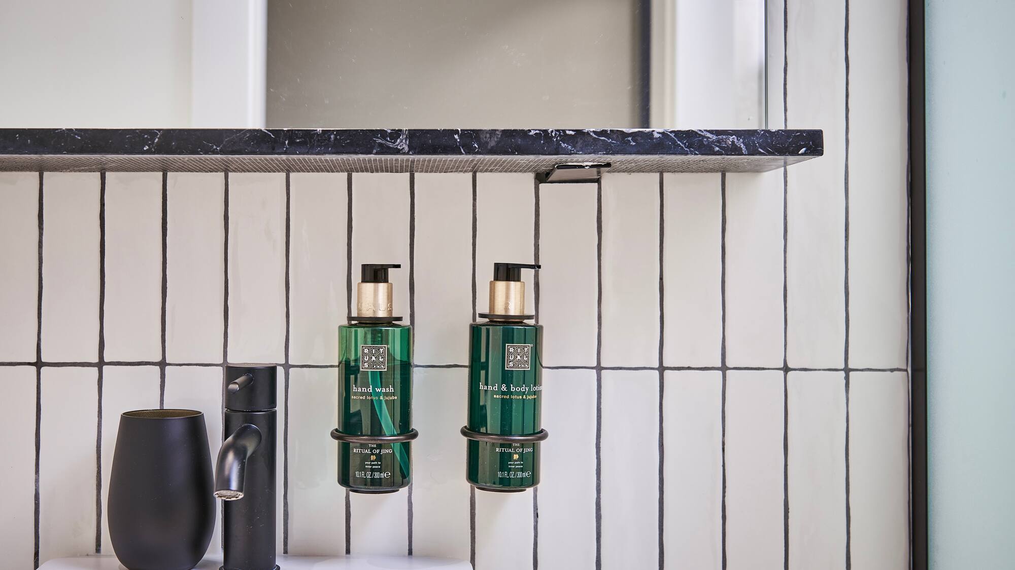 a bathroom with a sink and soap dispenser