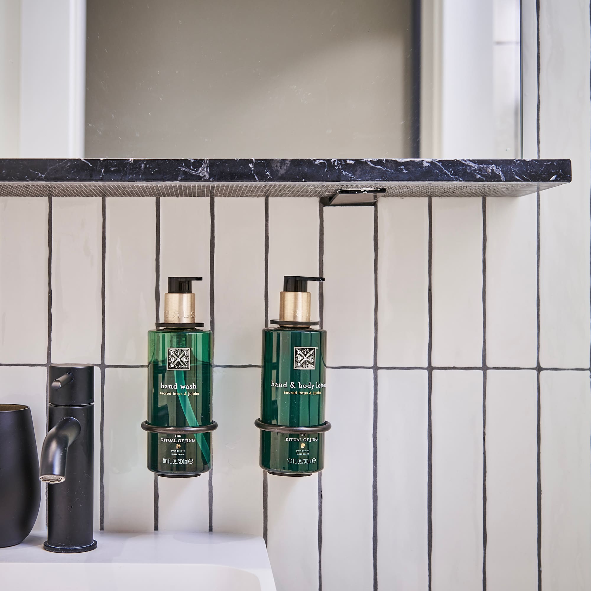 a bathroom with a sink and soap dispenser
