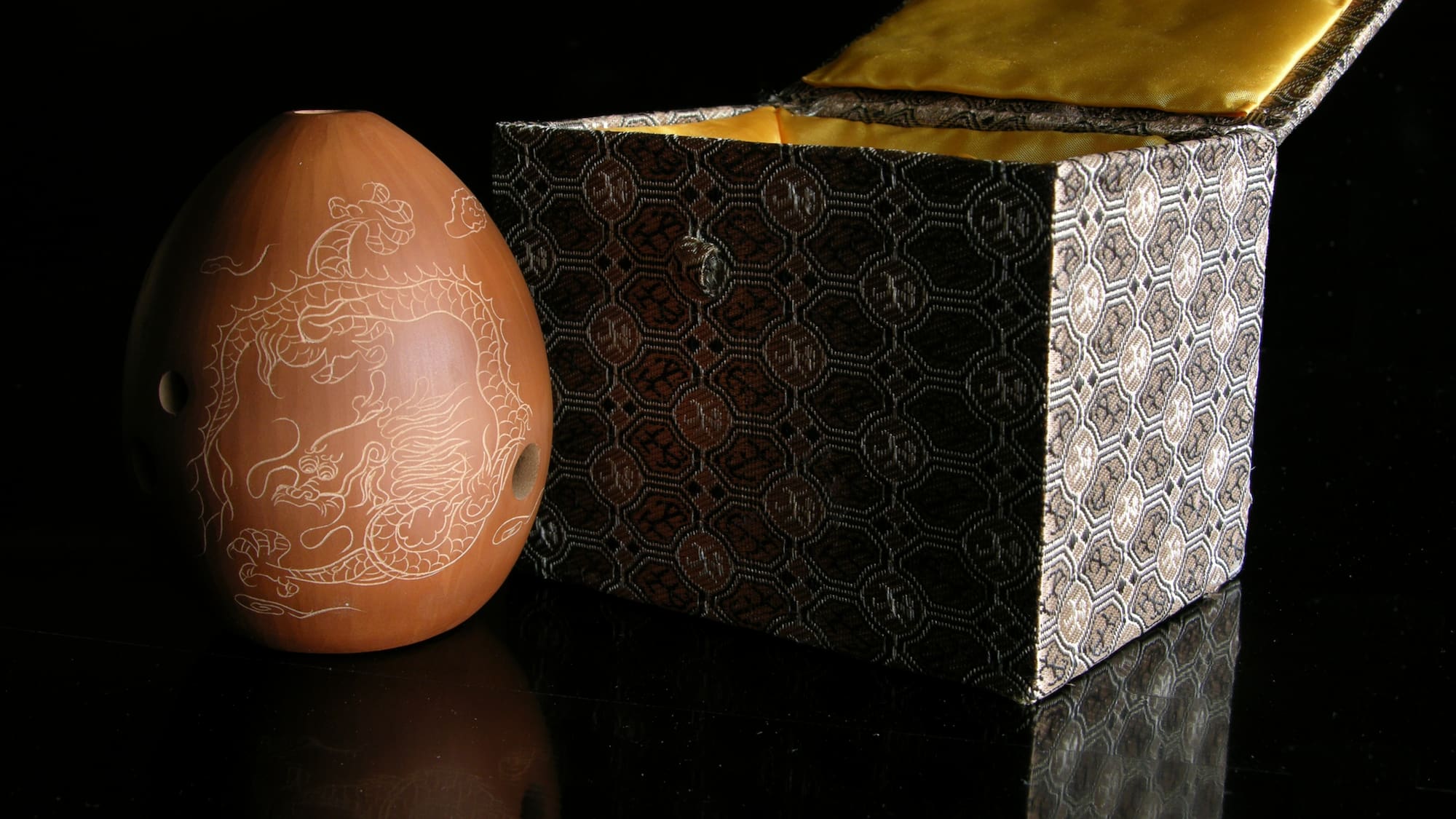 a brown ceramic egg next to a box