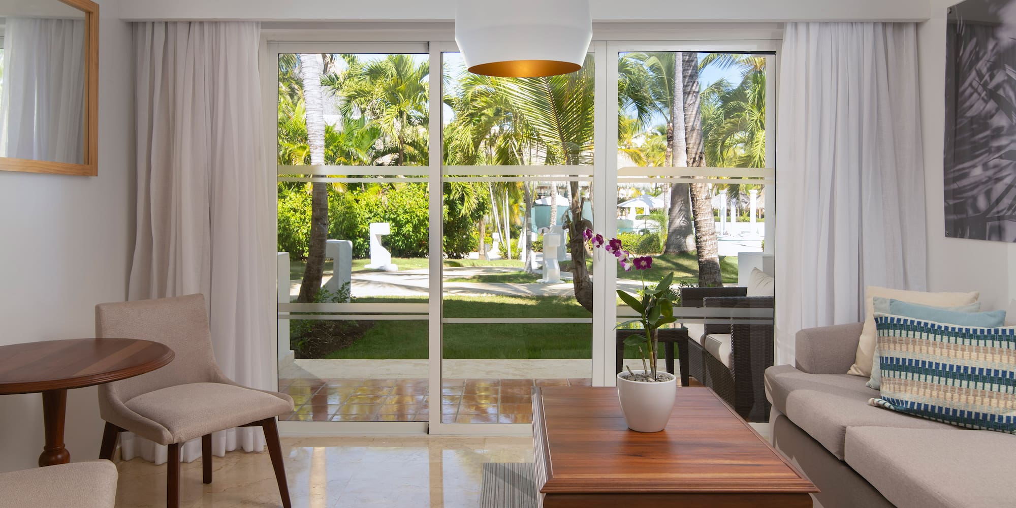 a living room with a table and chairs