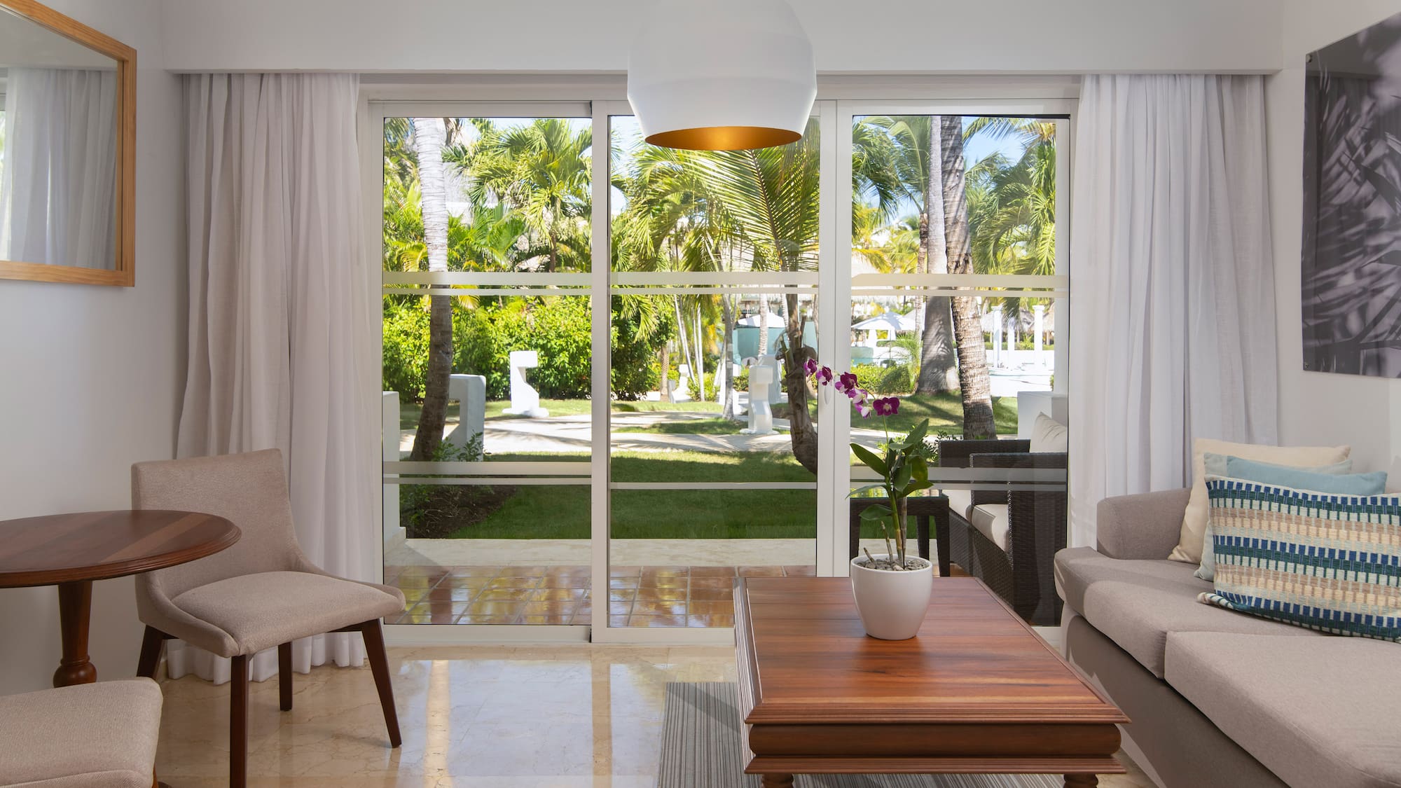 a living room with a table and chairs