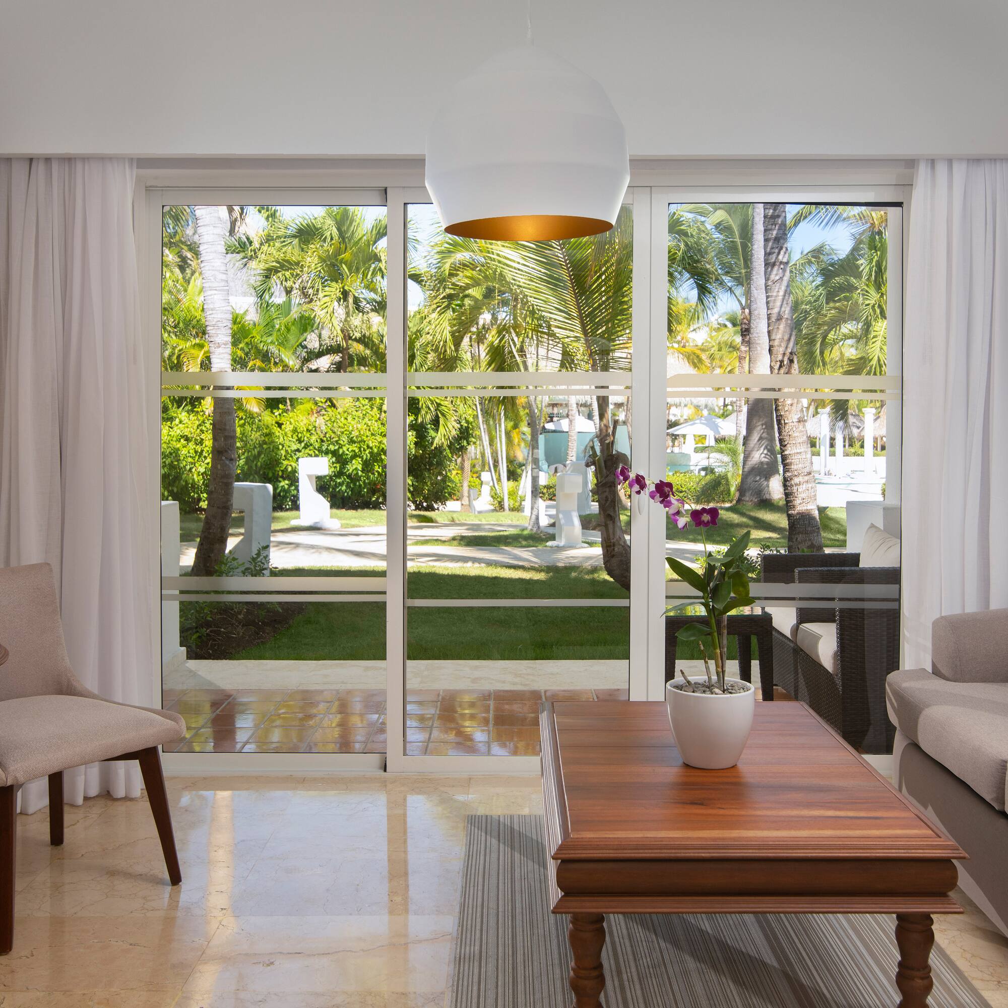 a living room with a table and chairs