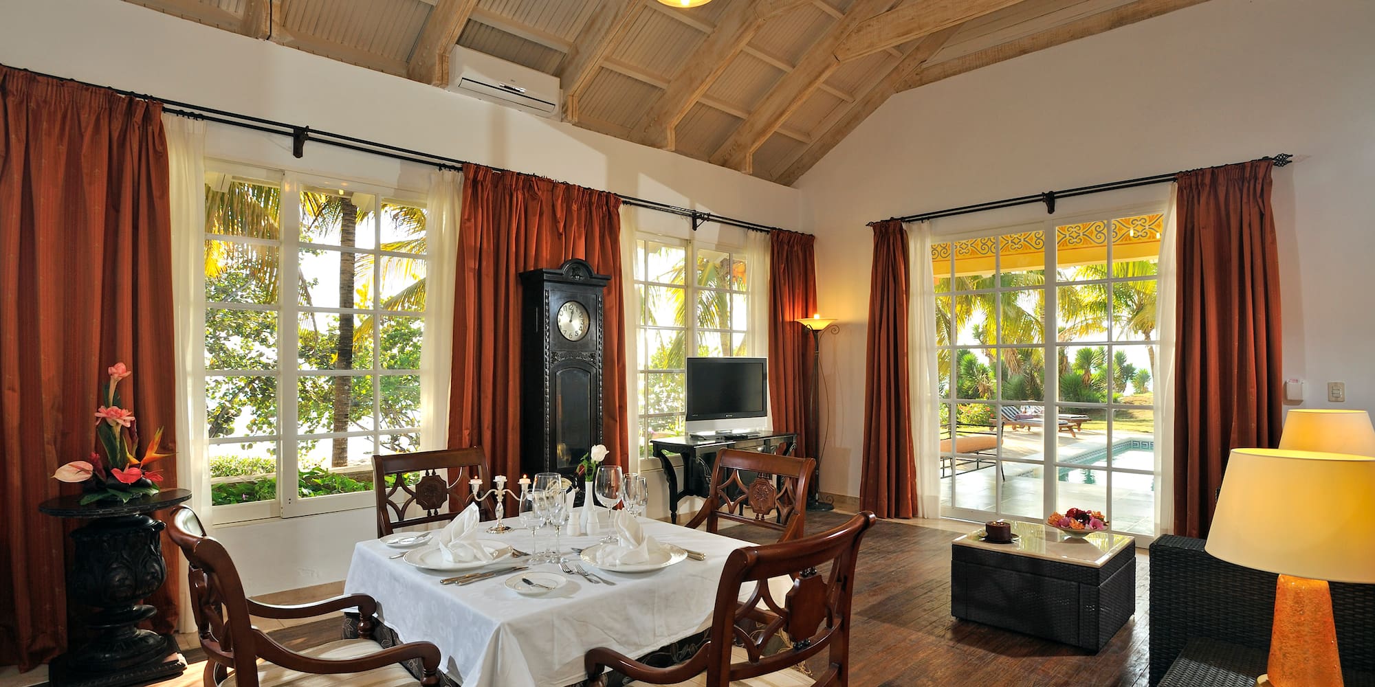 a dining room with a clock and a table