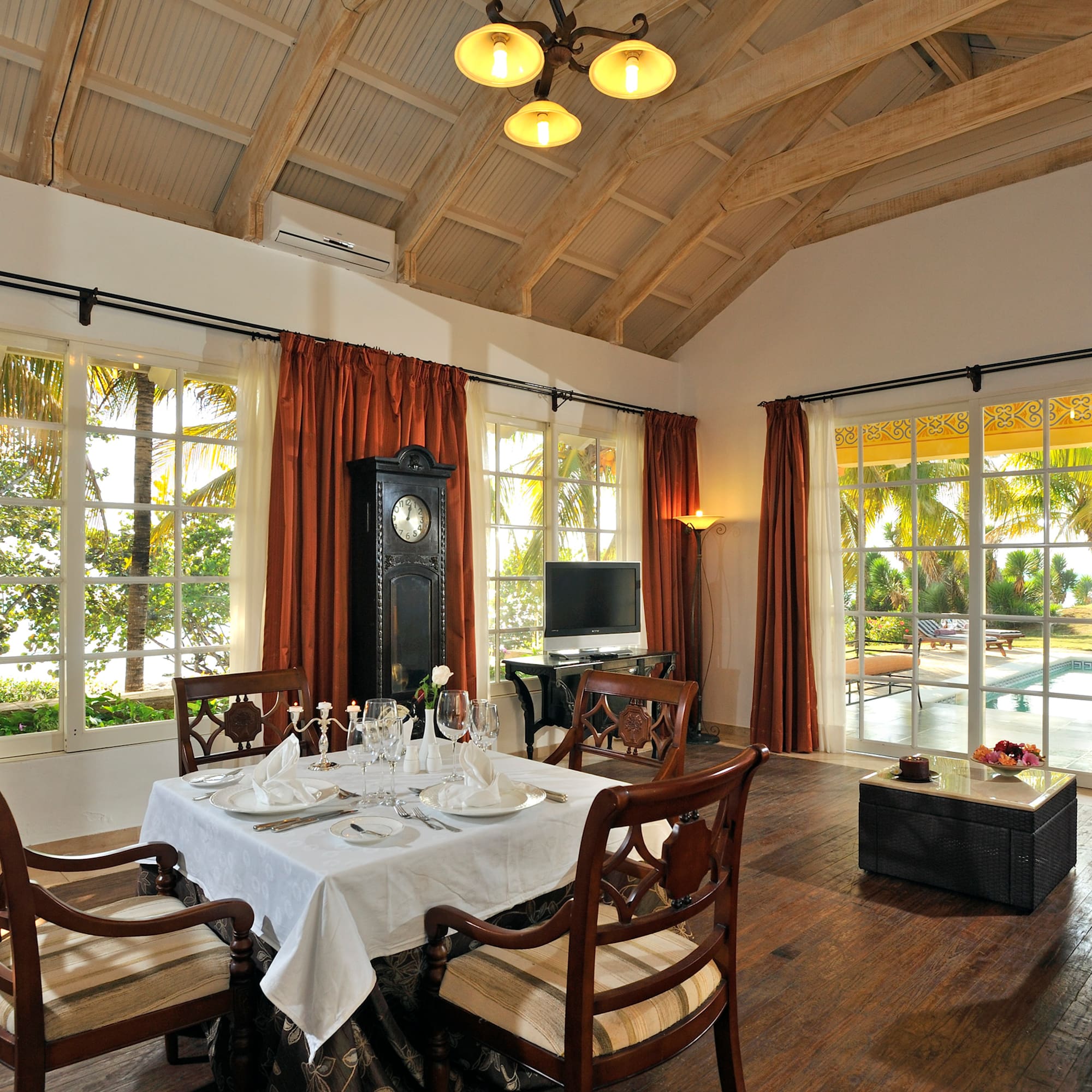 a dining room with a clock and a table