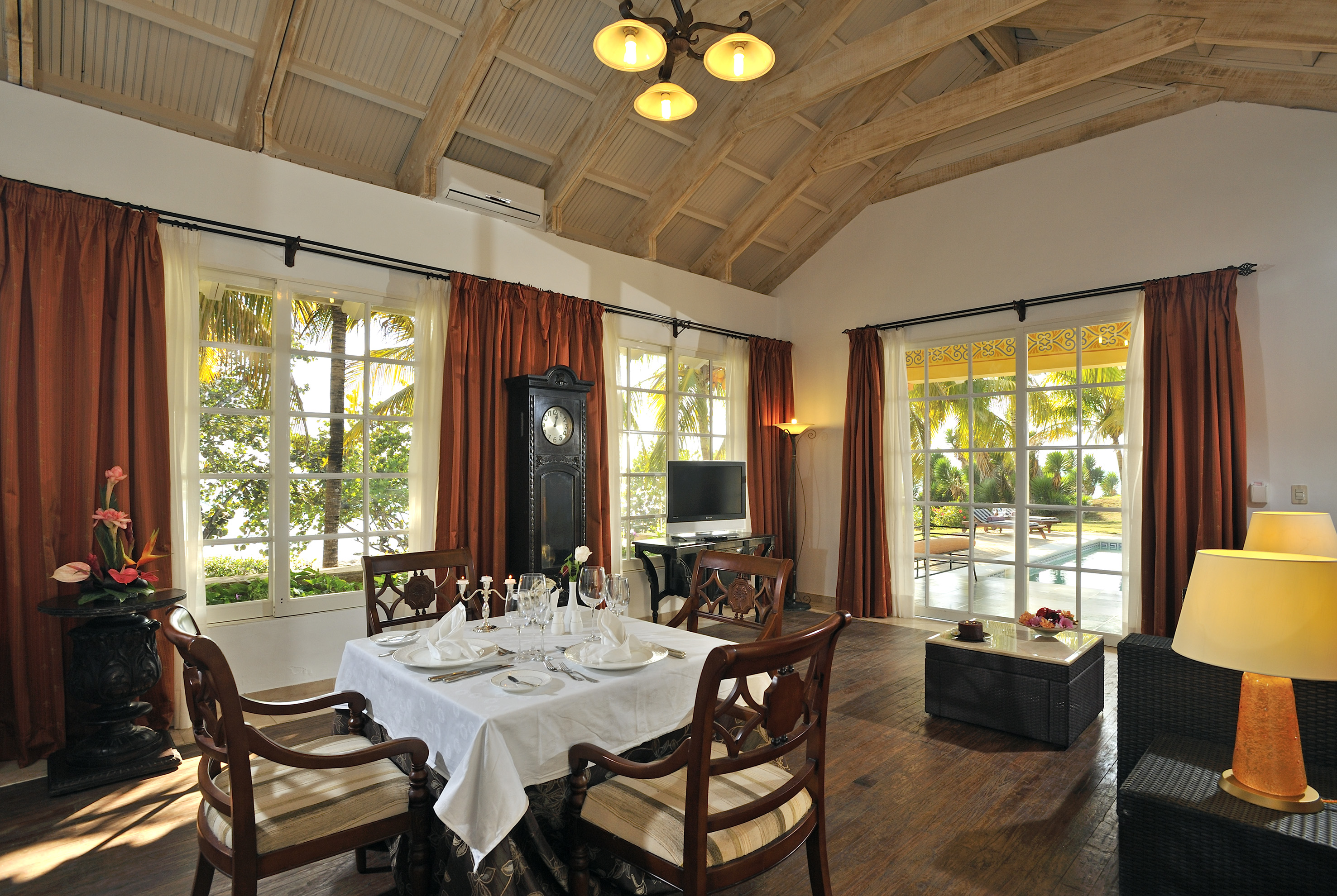 a dining room with a clock and a table