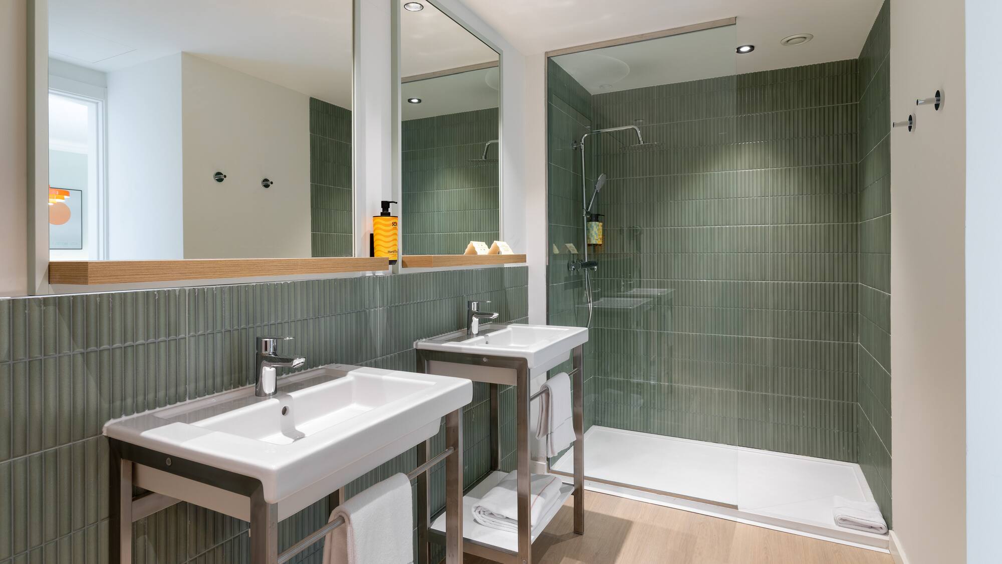 a bathroom with a shower and two sinks