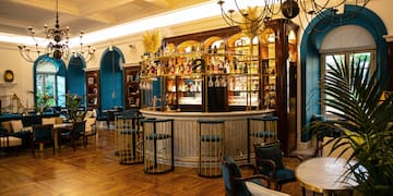 a room with a bar and chairs