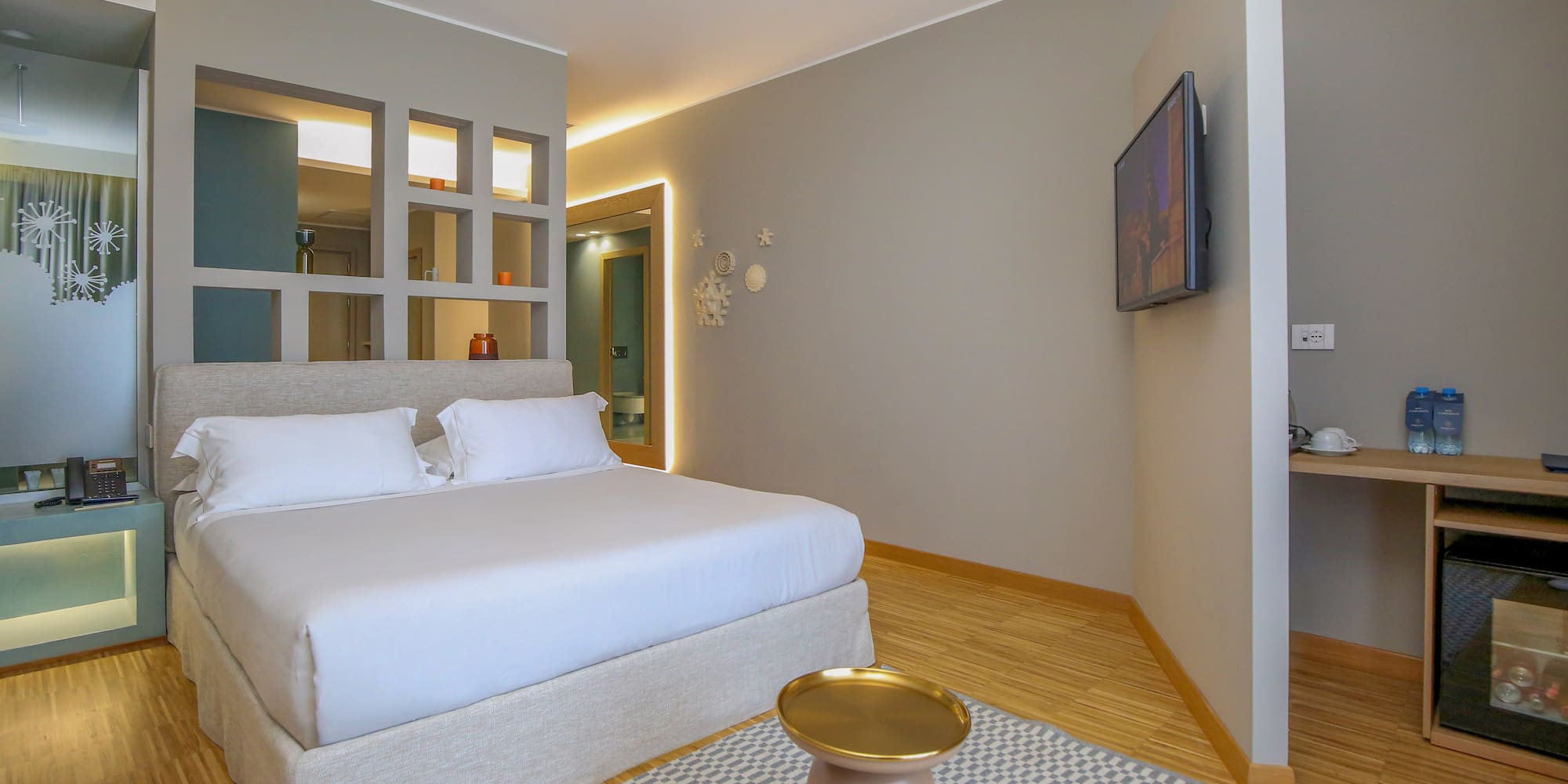 a bedroom with a bed and a tv