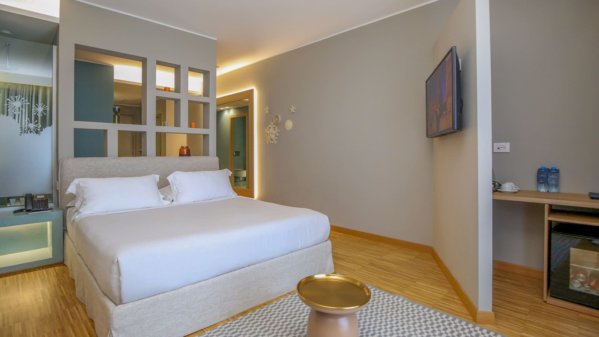 a bedroom with a bed and a tv