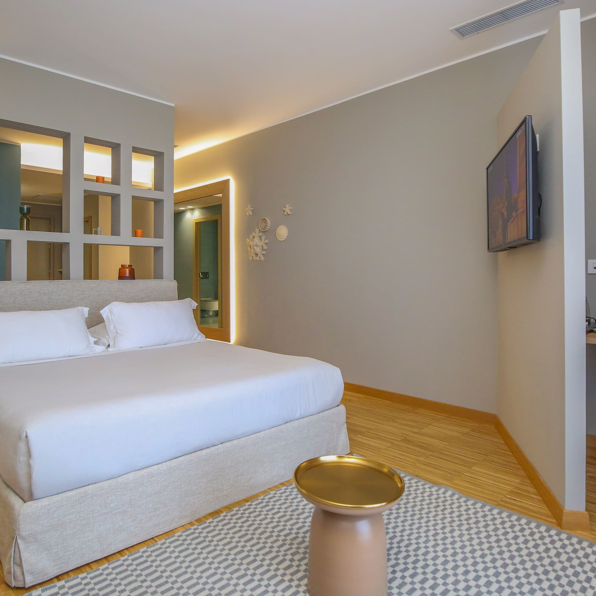 a bedroom with a bed and a tv